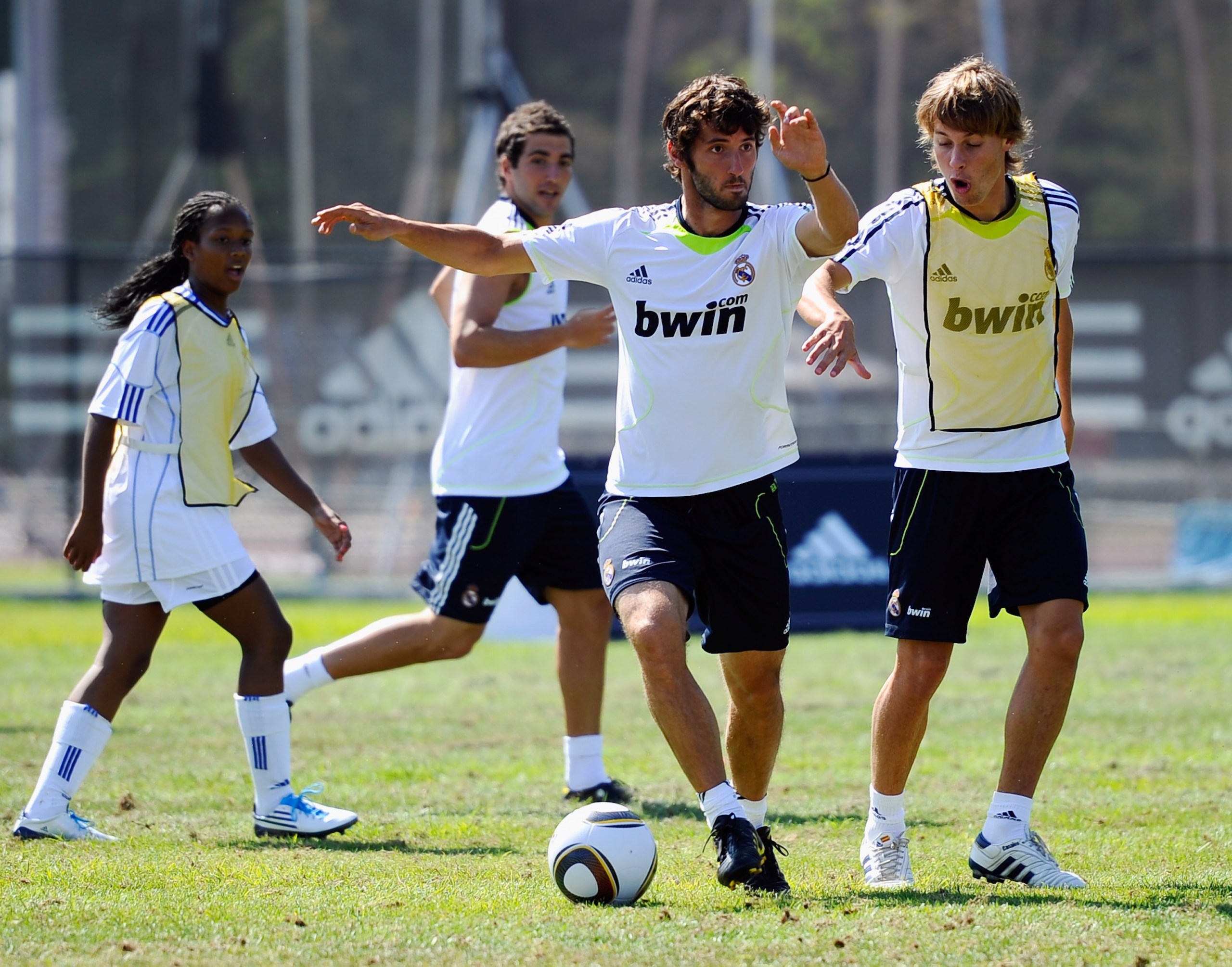 LOS ANGELES, CA - AUGUST 05:  Esteban Granero #24 (C) and Sergio Canales #27 of Real Madrid and  local youth soccer players participate in the Adidas training on August 5, 2010 in Westwood section of Los Angeles, California.  (Photo by Kevork Djansezian/G