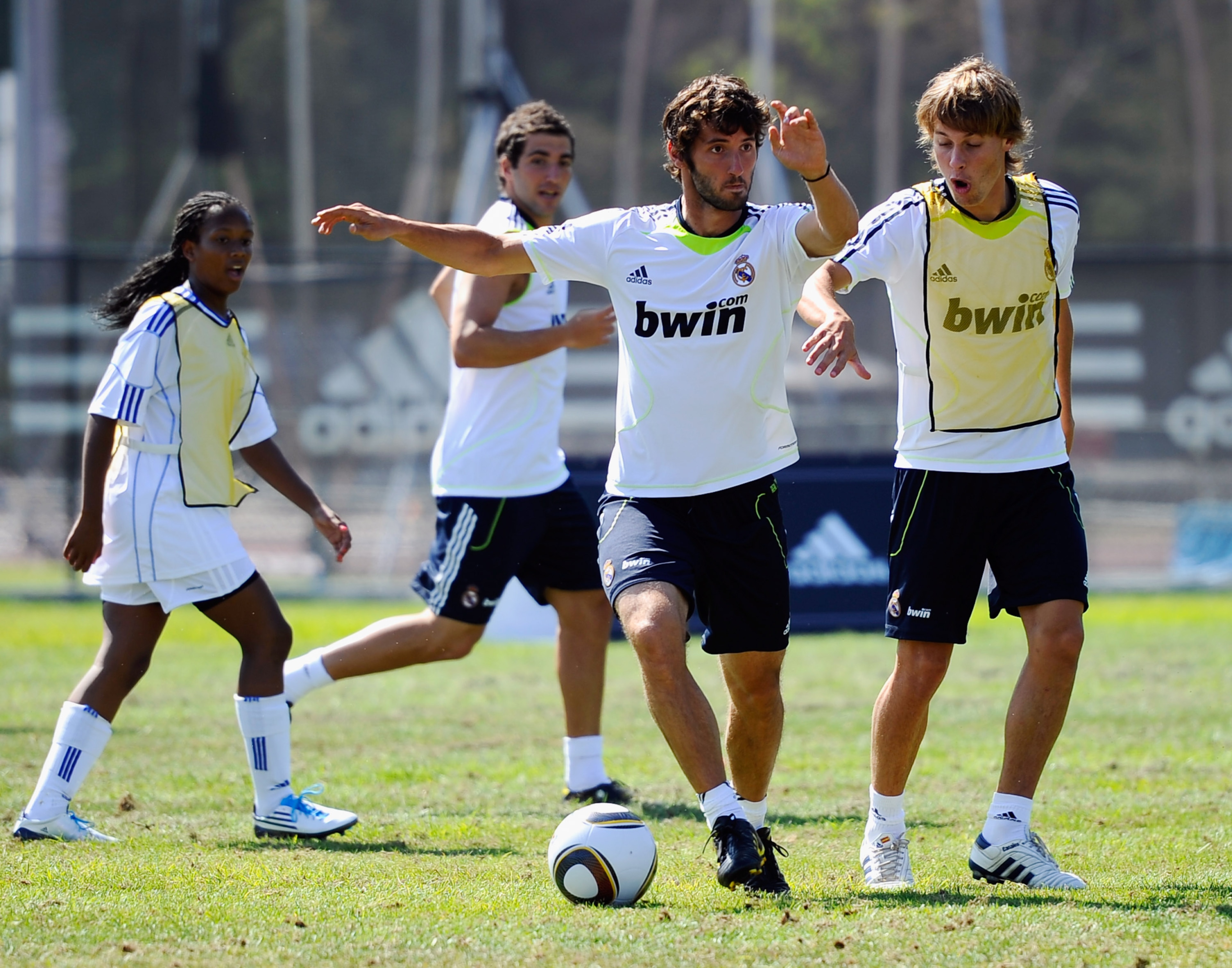 LOS ANGELES, CA - AUGUST 05:  Esteban Granero #24 (C) and Sergio Canales #27 of Real Madrid and  local youth soccer players participate in the Adidas training on August 5, 2010 in Westwood section of Los Angeles, California.  (Photo by Kevork Djansezian/G