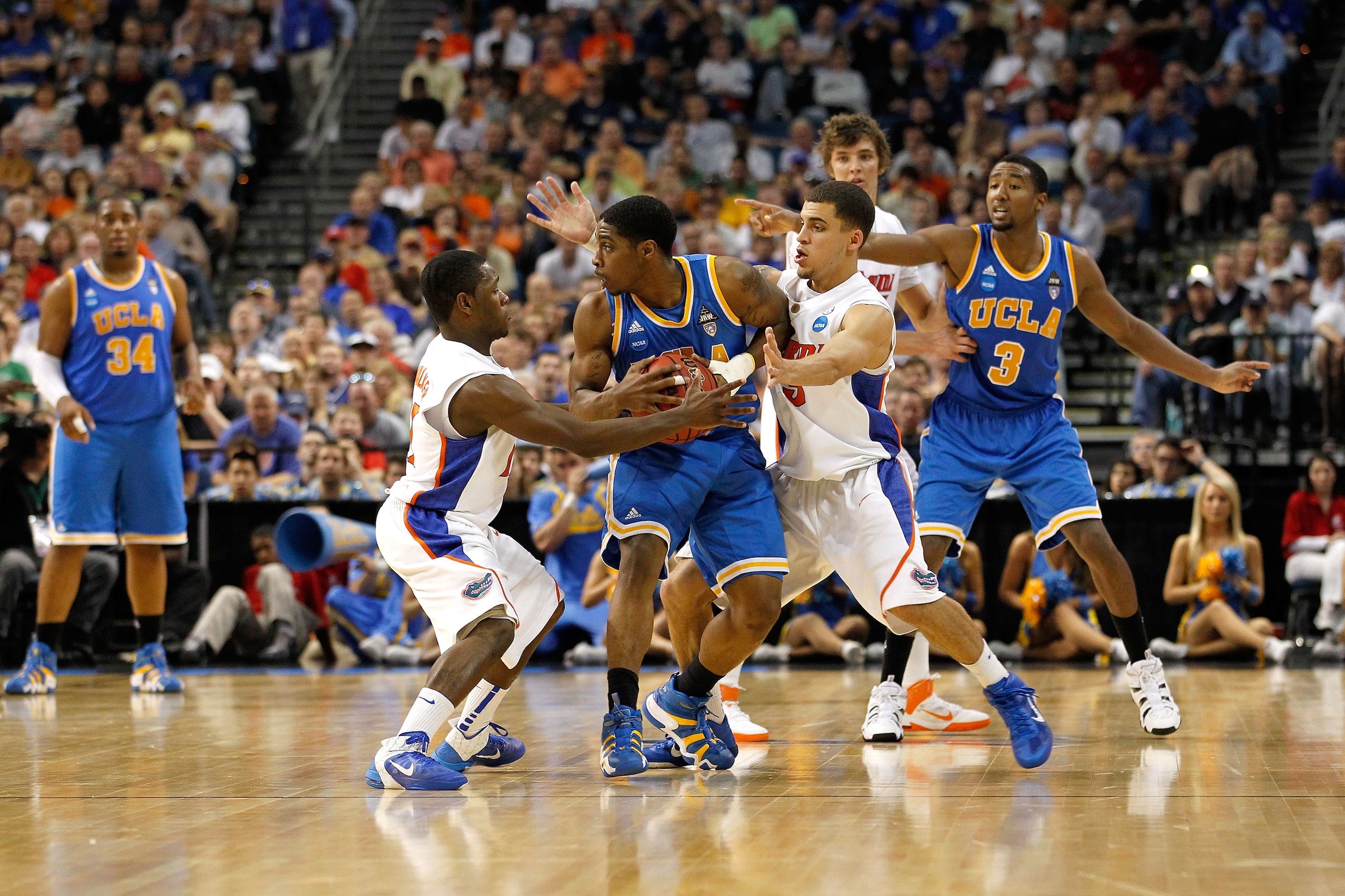 TAMPA, FL - MARCH 19:  Lazeric Jones #11 of the UCLA Bruins attempts to control the ball against the defense of Erving Walker #11 (L) and Scottie Wilbekin #5 of the Florida Gators during the third round of the 2011 NCAA men's basketball tournament at St.