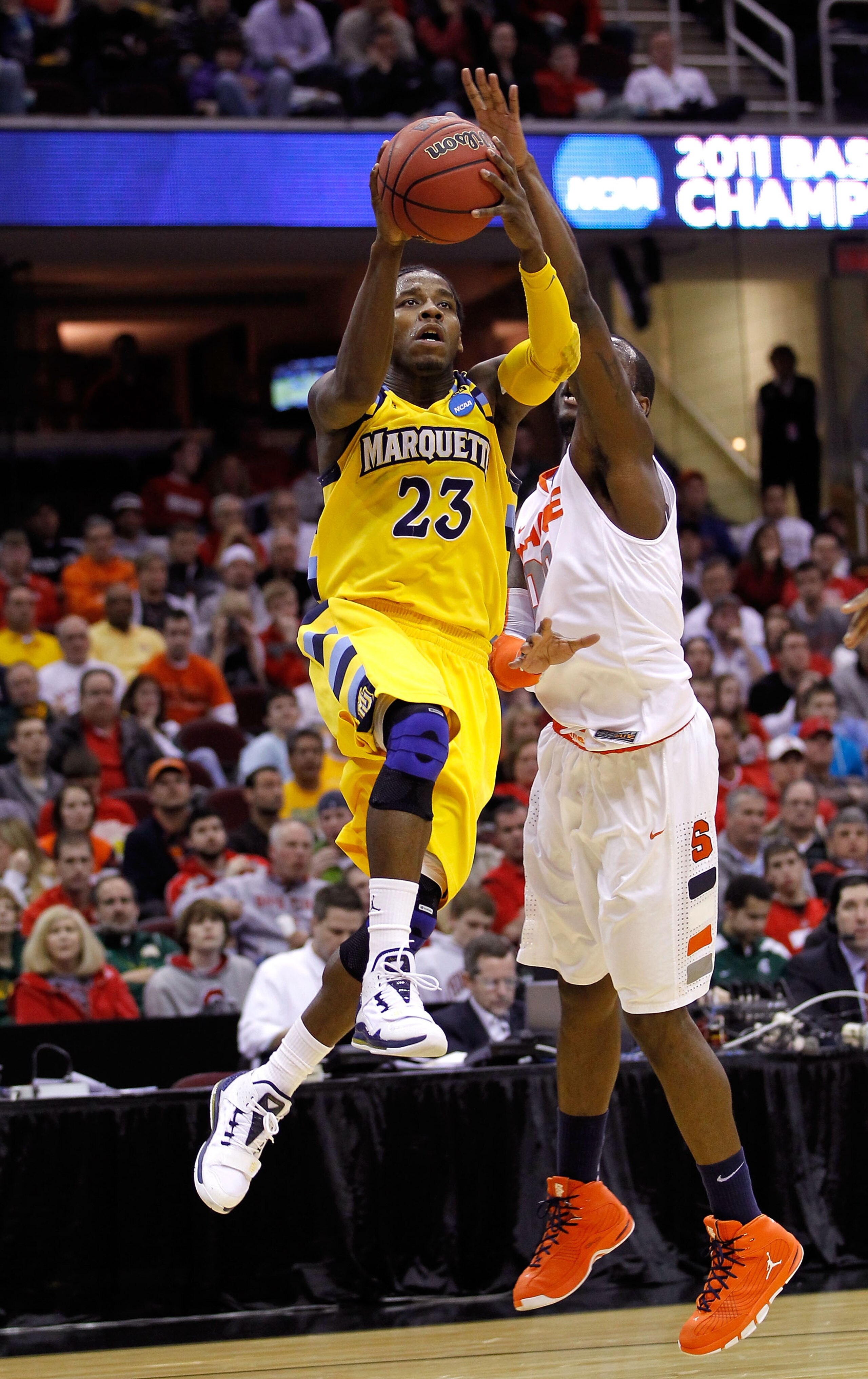 CLEVELAND, OH - MARCH 20: Dwight Buycks #23 of the Marquette Golden Eagles drives to the basket against Rick Jackson #00 of the Syracuse Orange during the third of the 2011 NCAA men's basketball tournament at Quicken Loans Arena on March 20, 2011 in Cleve