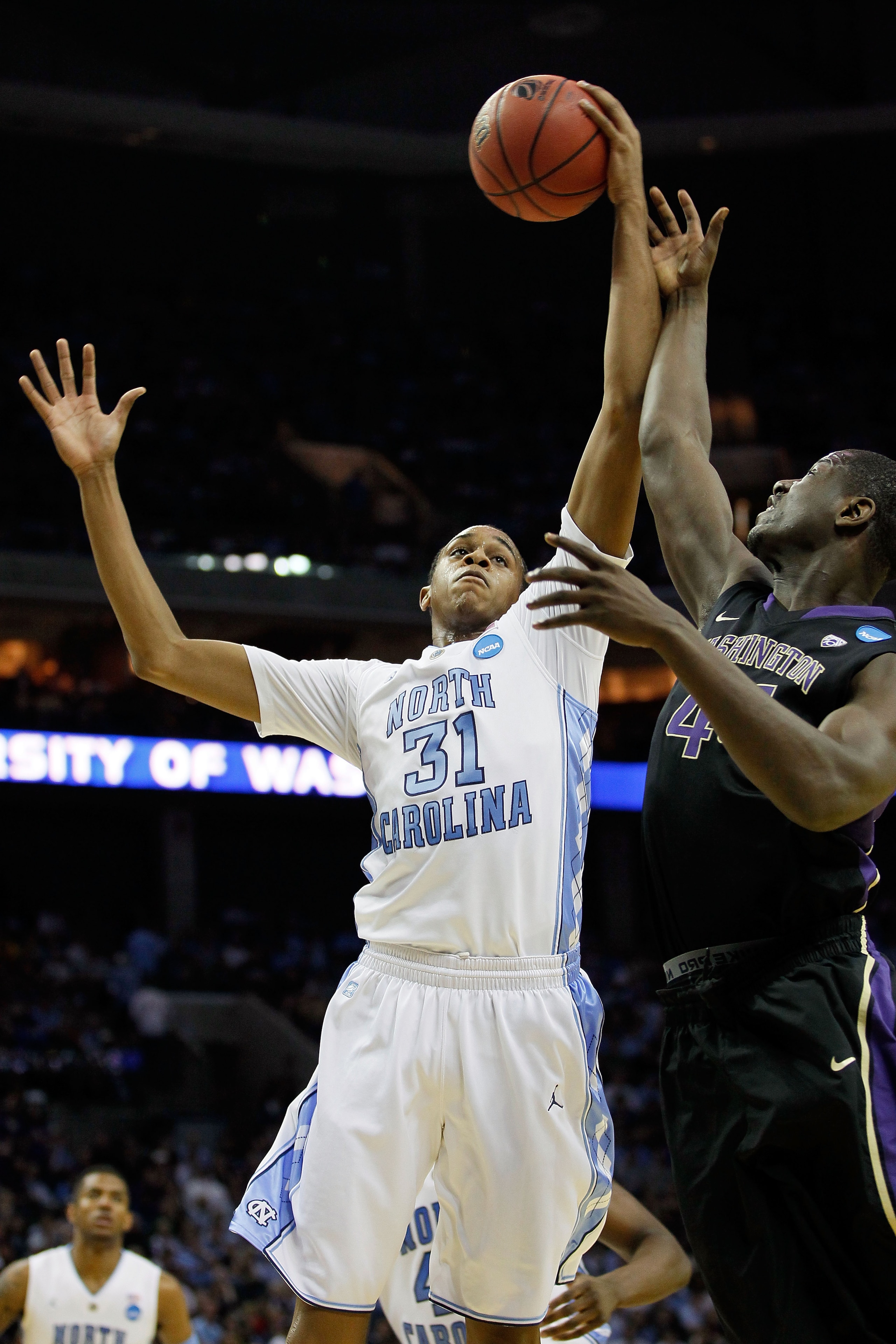 CHARLOTTE, NC - MARCH 20:  John Henson #31 of the North Carolina Tar Heels goes up for a rebound against Darnell Gant #44 of the Washington Huskies during the third round of the 2011 NCAA men's basketball tournament at Time Warner Cable Arena on March 20,