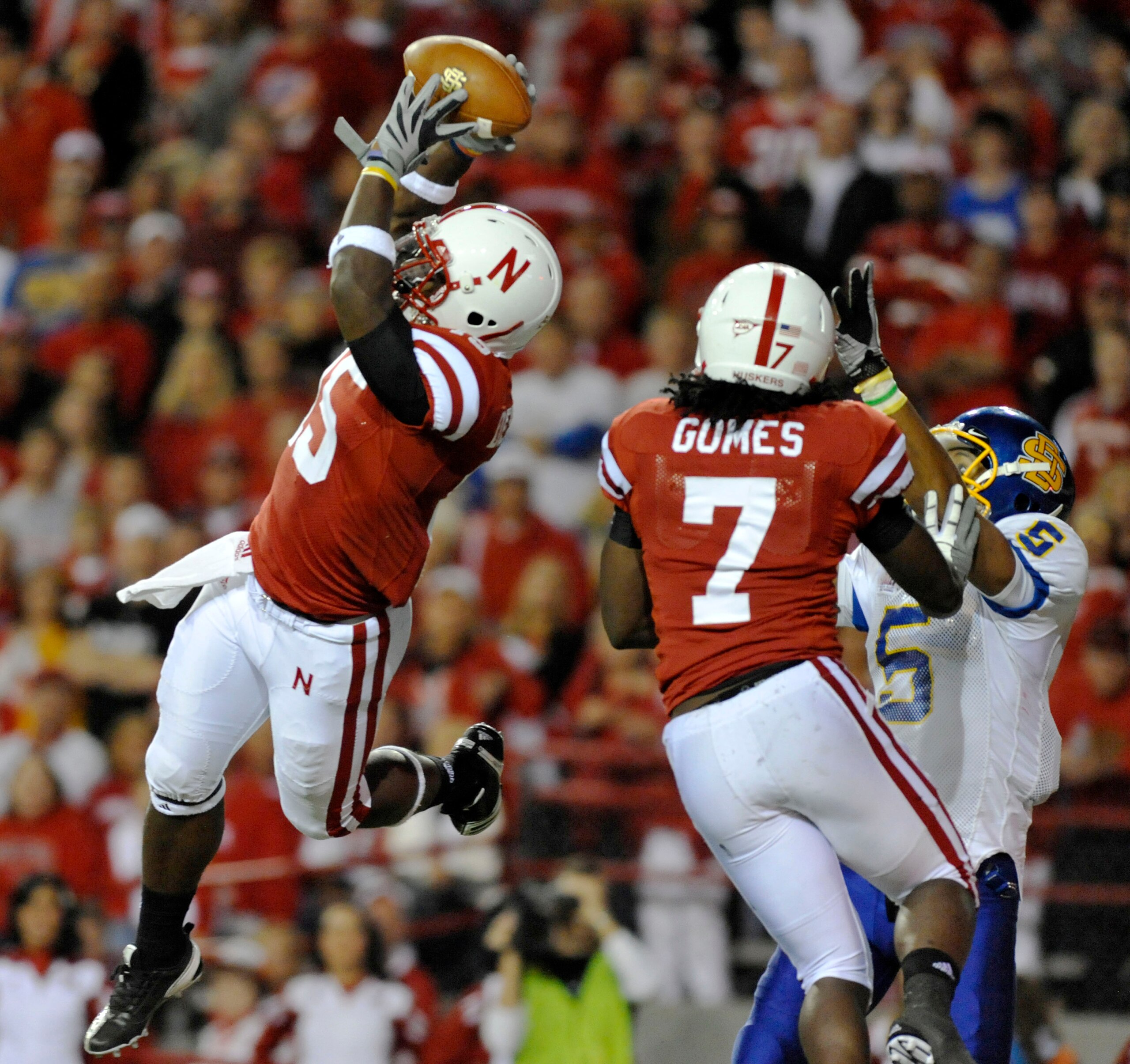 LINCOLN, NB - SEPTEMBER 25: Cornerback Alfonzo Dennard #15 of the Nebraska Cornuskers intercepts a ball from  wide receiver Aaron Rollin #5 of the South Dakota State Jackrabbits during second half action of their game at Memorial Stadium on September 25,