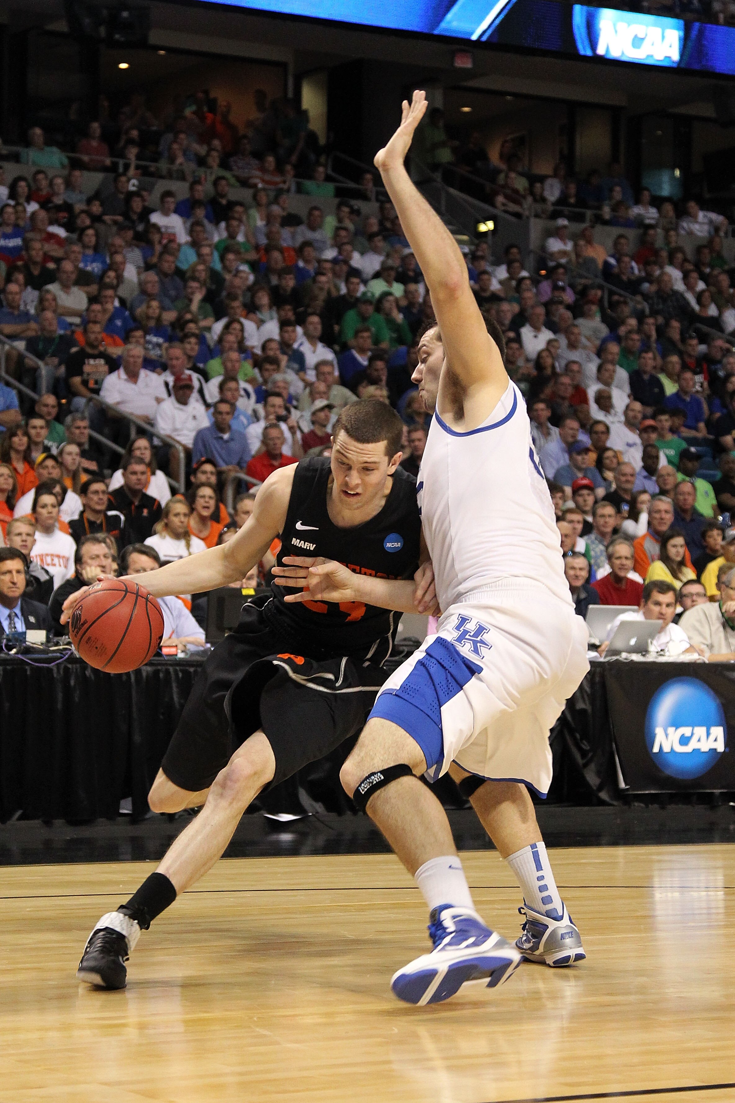 TAMPA, FL - MARCH 17:  Will Barrett #24 of the Princeton Tigers drives against Josh Harrellson #55 of the Kentucky Wildcats during the second round of the 2011 NCAA men's basketball tournament at St. Pete Times Forum on March 17, 2011 in Tampa, Florida.