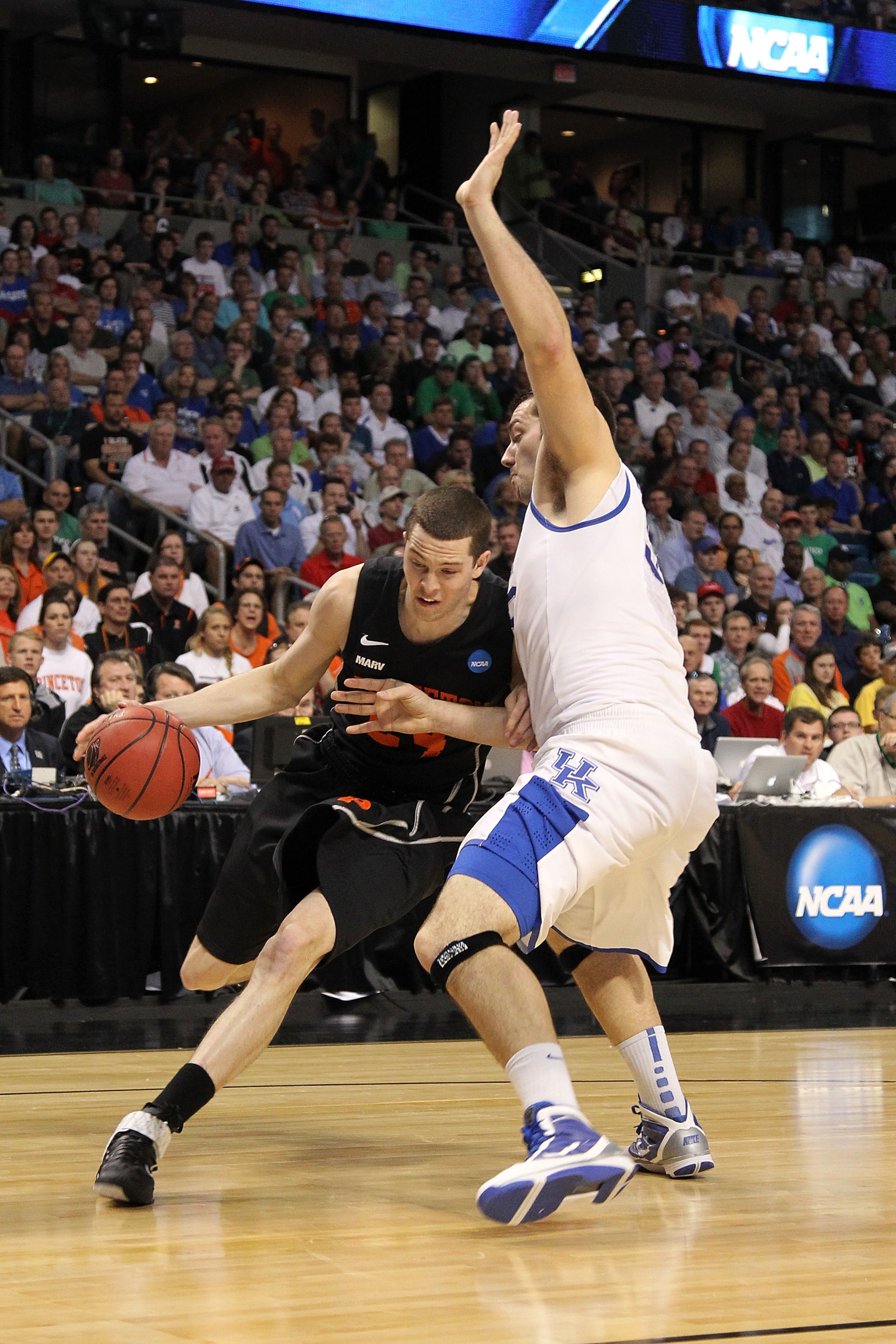 TAMPA, FL - MARCH 17:  Will Barrett #24 of the Princeton Tigers drives against Josh Harrellson #55 of the Kentucky Wildcats during the second round of the 2011 NCAA men's basketball tournament at St. Pete Times Forum on March 17, 2011 in Tampa, Florida.