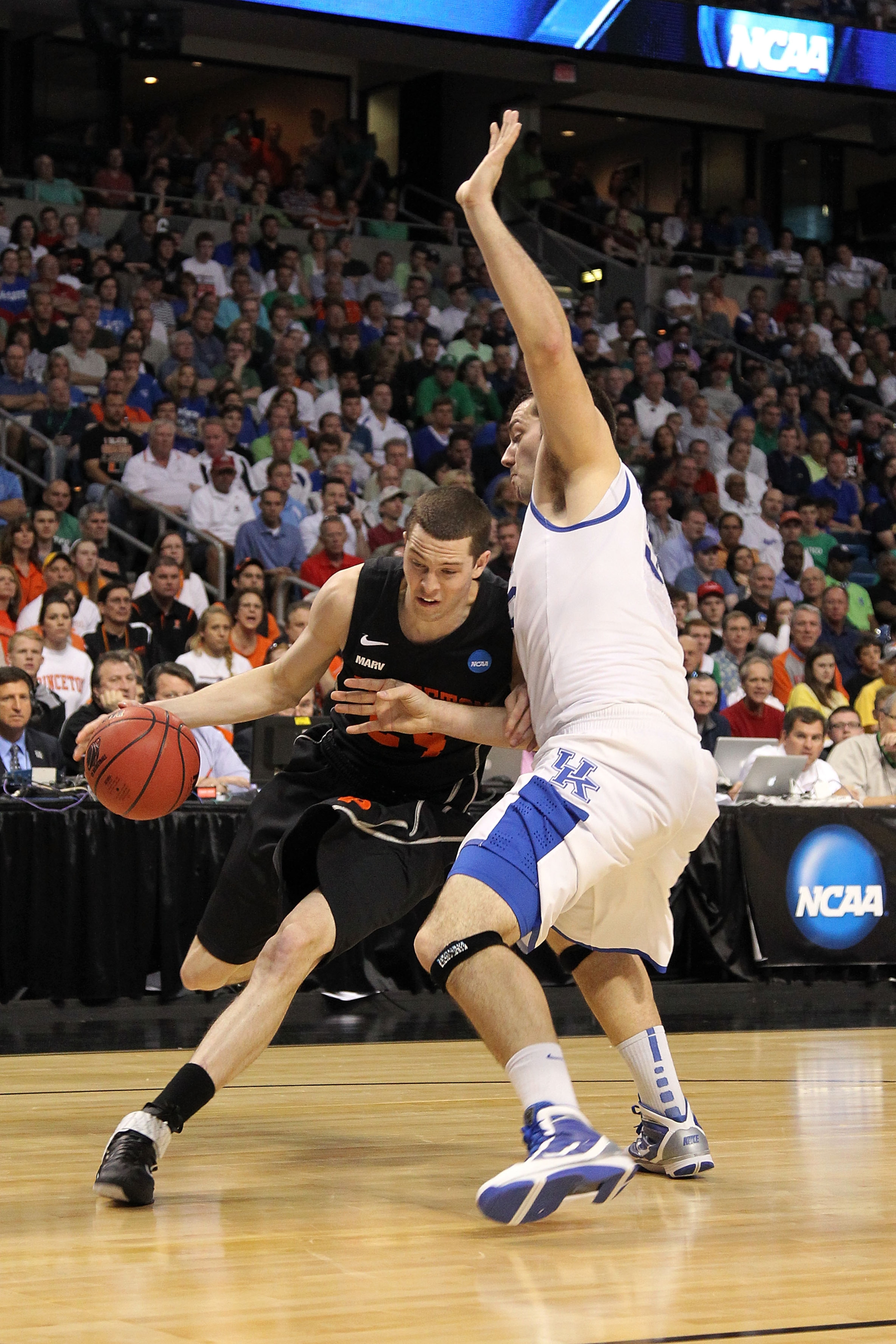 TAMPA, FL - MARCH 17:  Will Barrett #24 of the Princeton Tigers drives against Josh Harrellson #55 of the Kentucky Wildcats during the second round of the 2011 NCAA men's basketball tournament at St. Pete Times Forum on March 17, 2011 in Tampa, Florida.
