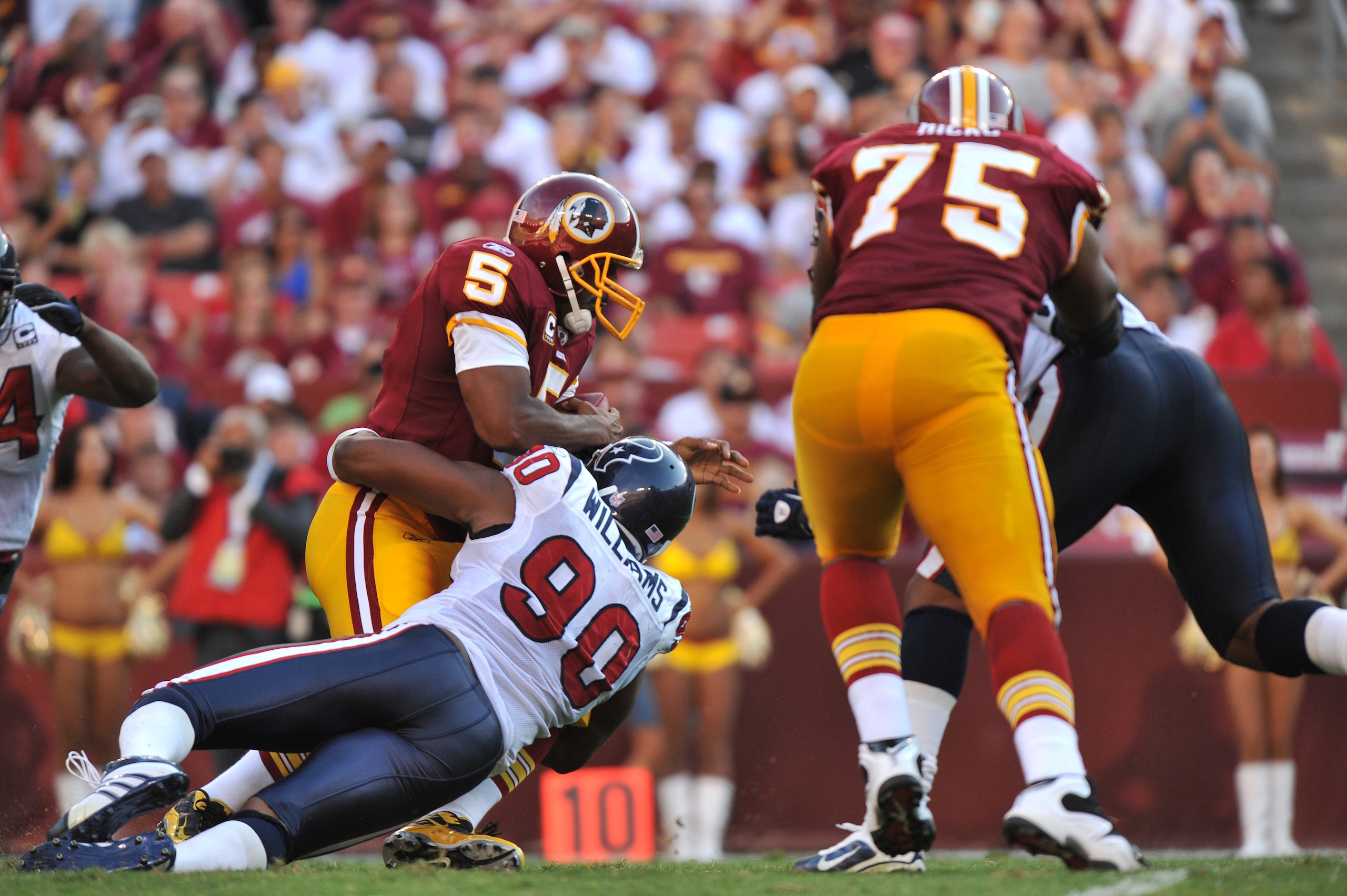 LANDOVER - SEPTEMBER 19: Mario Williams #90 of the Houston Texans sacks Donovan McNabb #5 of the Washington Redskins at FedExField on September 19, 2010 in Landover, Maryland. The Texans defeated the Redskins 30-27 in overtime. (Photo by Larry French/Get LANDOVER - SEPTEMBER 19: Mario Williams #90 of the Houston Texans sacks Donovan McNabb #5 of the Washington Redskins at FedExField on September 19, 2010 in Landover, Maryland. The Texans defeated the Redskins 30-27 in overtime. (Photo by Larry French/Get