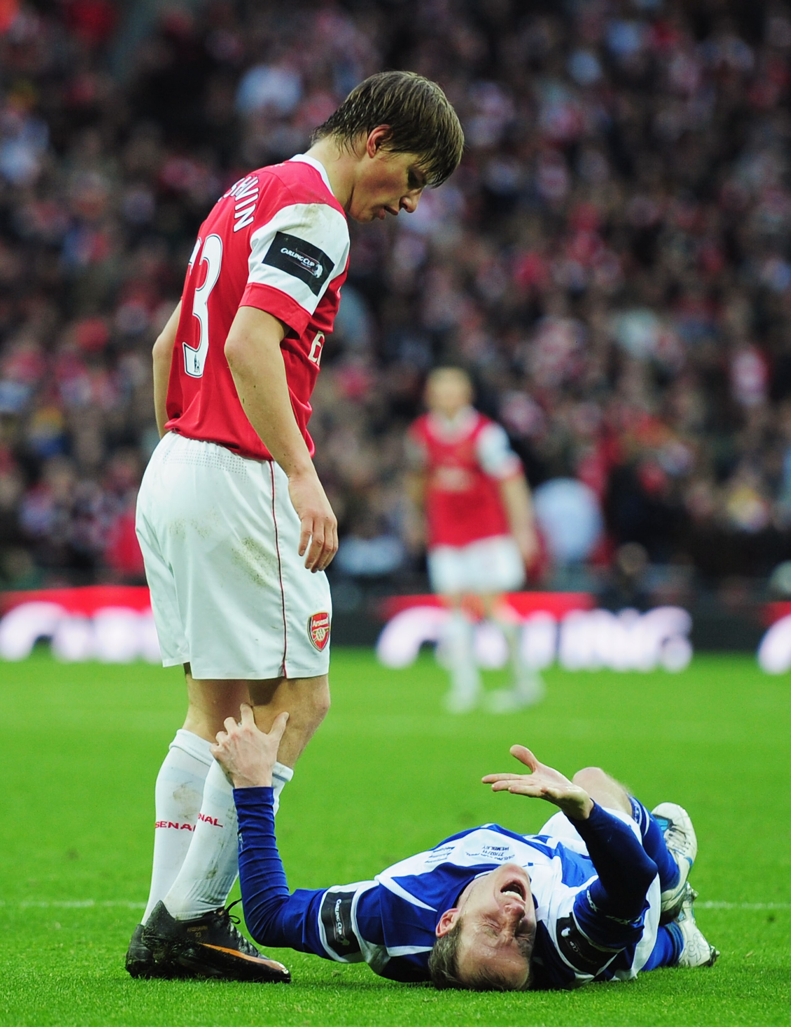 LONDON, ENGLAND - FEBRUARY 27:  Lee Bowyer of Birmingham City grimaces as Andrey Arshavin of Arsenal looks on during the Carling Cup Final between Arsenal and Birmingham City at Wembley Stadium on February 27, 2011 in London, England.  (Photo by Shaun Bot