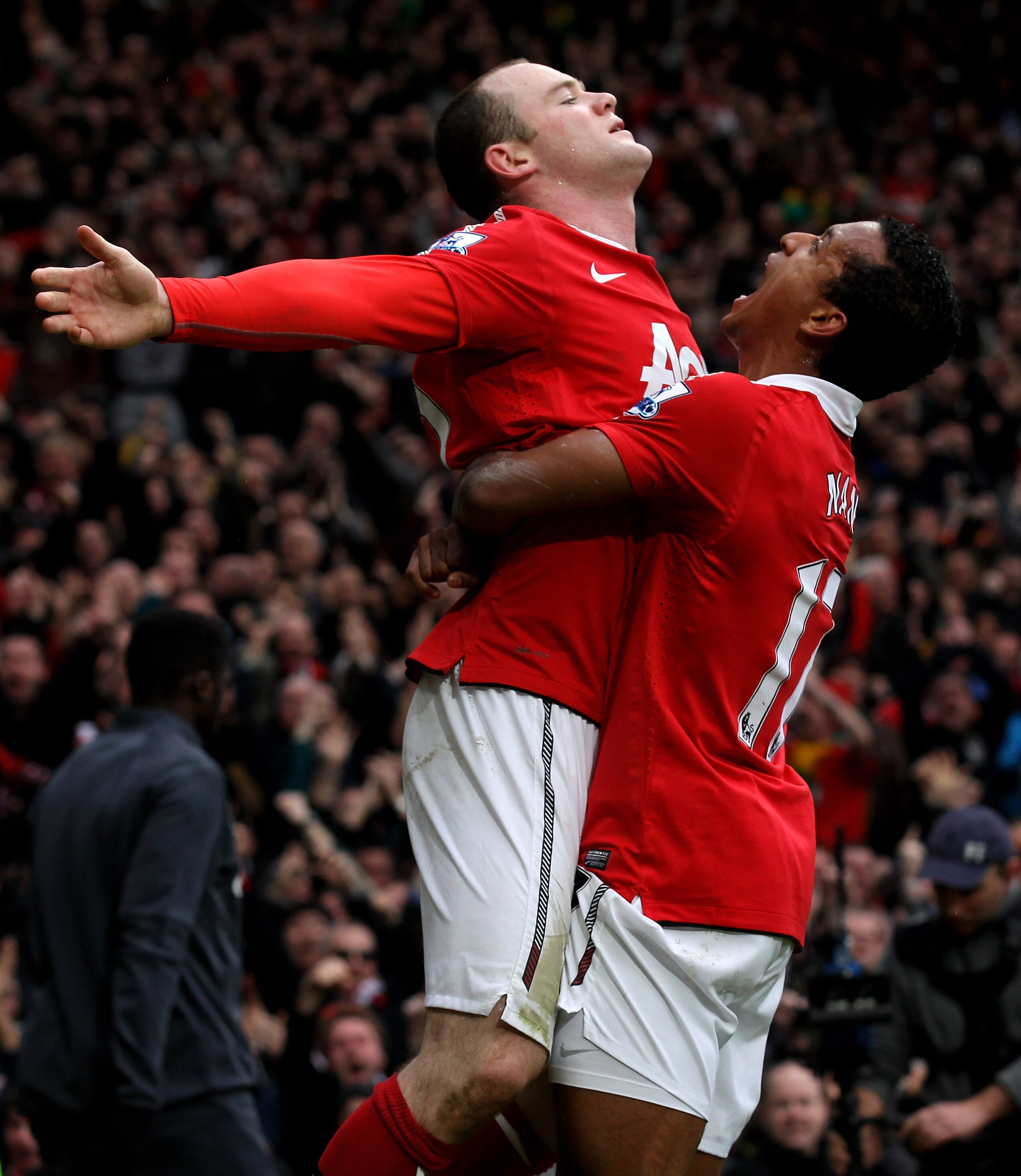 MANCHESTER, ENGLAND - FEBRUARY 12:  Wayne Rooney of Manchester United celebrates with teammate Nani (R) after he scores a goal from an overhead kick during the Barclays Premier League match between Manchester United and Manchester City at Old Trafford on