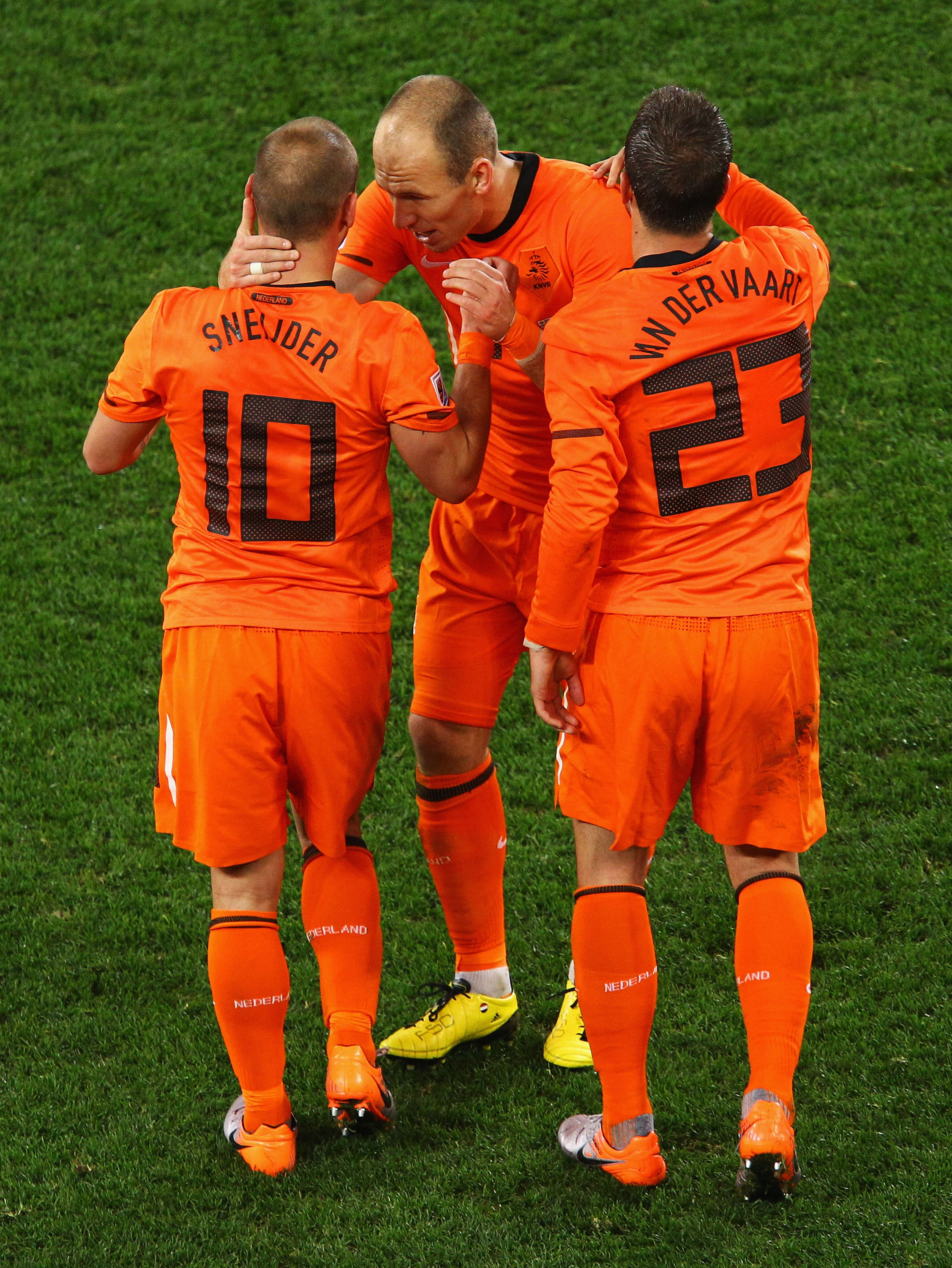 CAPE TOWN, SOUTH AFRICA - JULY 06:  Wesley Sneijder of the Netherlands celebrates scoring his side's second goal with team mates Arjen Robben and Rafael Van der Vaart during the 2010 FIFA World Cup South Africa Semi Final match between Uruguay and the Net