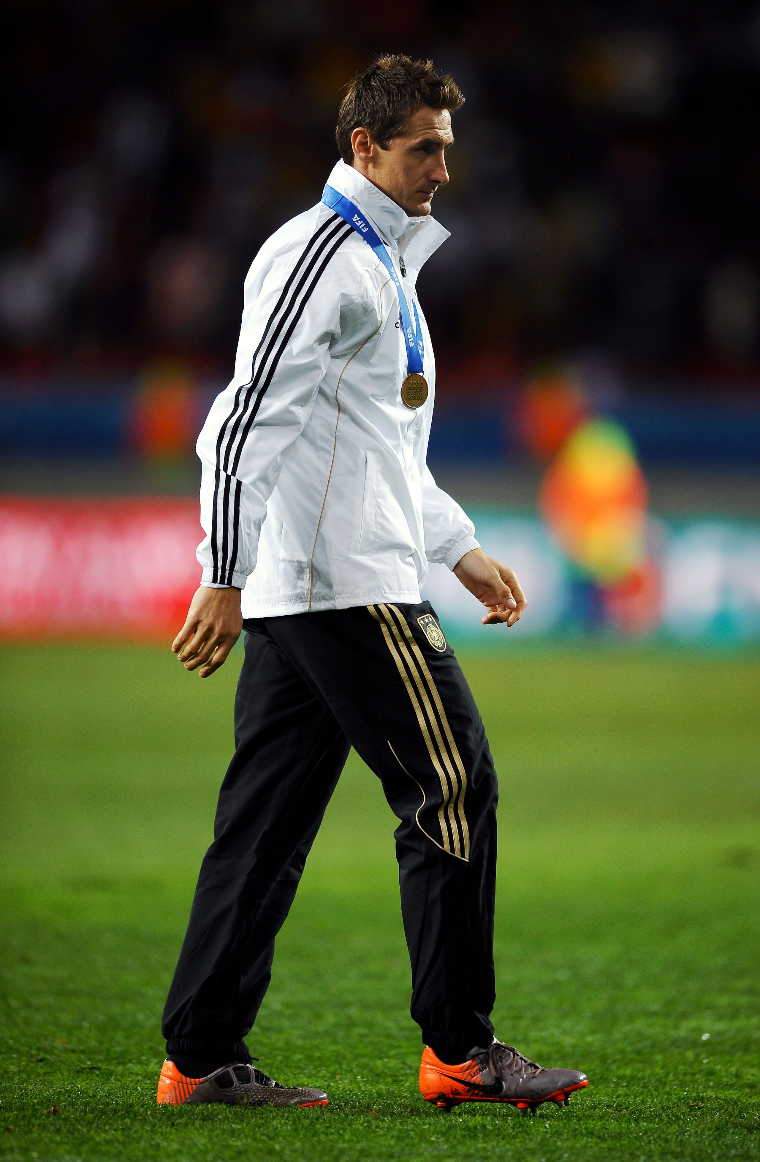 PORT ELIZABETH, SOUTH AFRICA - JULY 10:  Miroslav Klose of Germany walks away with his medal as his team celebrate victory and third place following the 2010 FIFA World Cup South Africa Third Place Play-off match between Uruguay and Germany at The Nelson