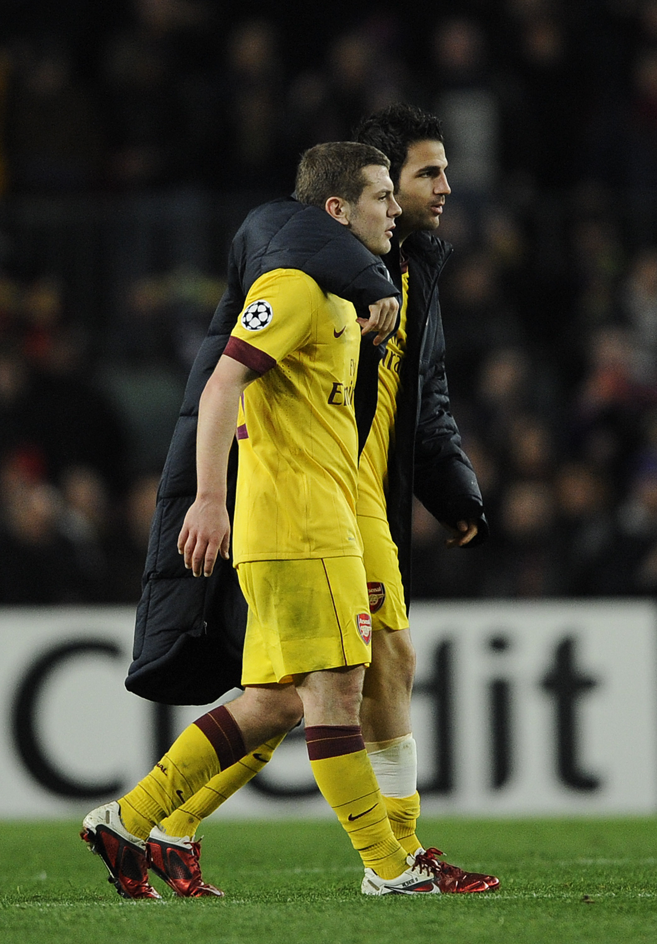 BARCELONA, SPAIN - MARCH 08:  Cesc Fabregas of Arsenal (R) consoles his team-mate Jack Wilshere of Arsenal at the end of the UEFA Champions League round of 16 second leg match between Barcelona and Arsenal at the Camp Nou stadium on March 8, 2011 in Barce