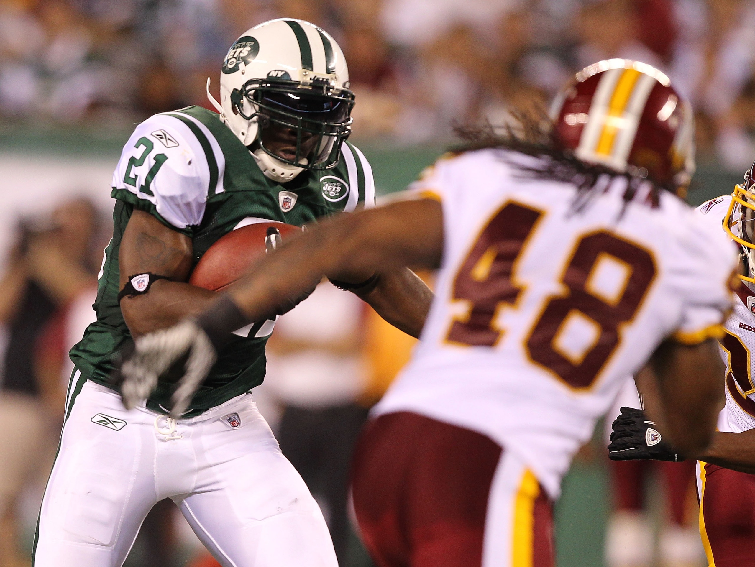 EAST RUTHERFORD, NJ - AUGUST 27:  LaDainian Tomlinson #21 of the New York Jets runs against Chris Horton #48 of the Washington Redskins  during their preseason game on August 27, 2010 at the New Meadowlands Stadium  in East Rutherford, New Jersey.  (Photo
