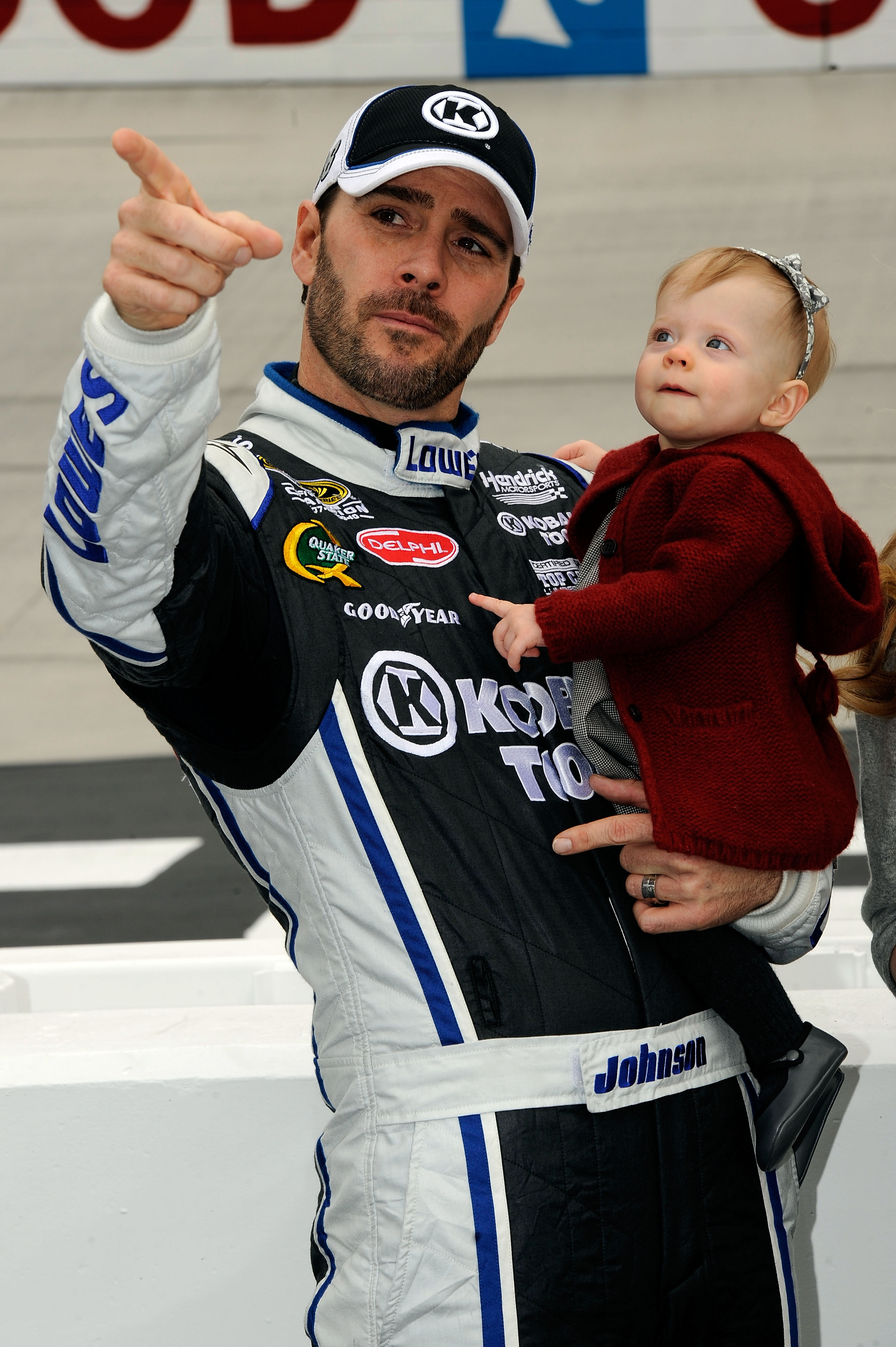 BRISTOL, TN - MARCH 20:  Jimmie Johnson (L), driver of the #48 Lowe's/Kobalt Tools Chevrolet, holds his daughter Genevieve Marie (C) on the grid prior to the start ofduring the NASCAR Sprint Cup Series Jeff Byrd 500 Presented By Food City at Bristol Motor