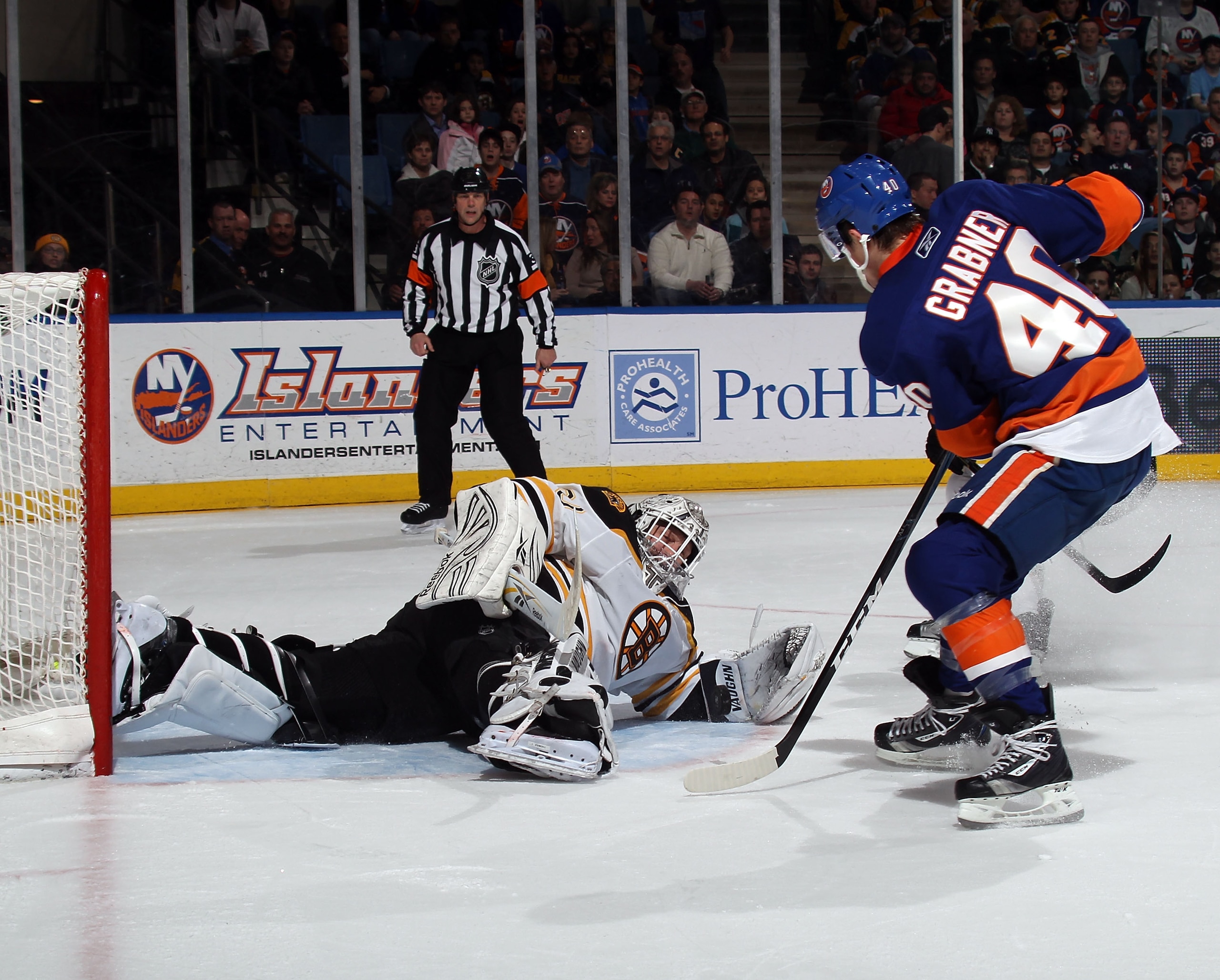 UNIONDALE, NY - MARCH 11: Tim Thomas #30 of the Boston Bruins stops Michael Grabner #40 of the New York Islanders during the second period at the Nassau Coliseum on March 11, 2011 in Uniondale, New York.  (Photo by Bruce Bennett/Getty Images)