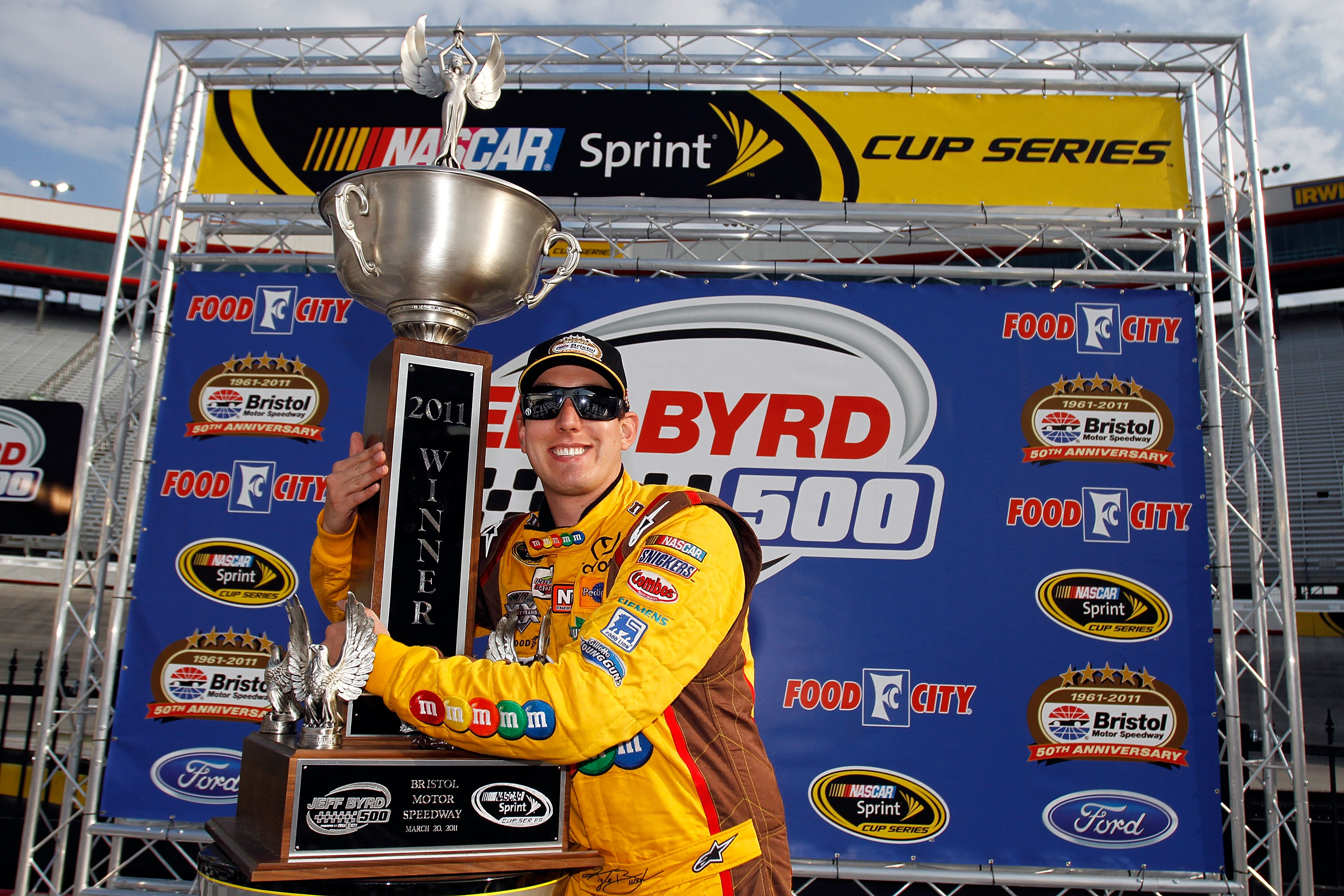 BRISTOL, TN - MARCH 20:   Kyle Busch, driver of the #18 M&M's Toyota, celebrates in Victory Lane after winning the NASCAR Sprint Cup Series Jeff Byrd 500 Presented By Food City at Bristol Motor Speedway on March 20, 2011 in Bristol, Tennessee.  (Photo by