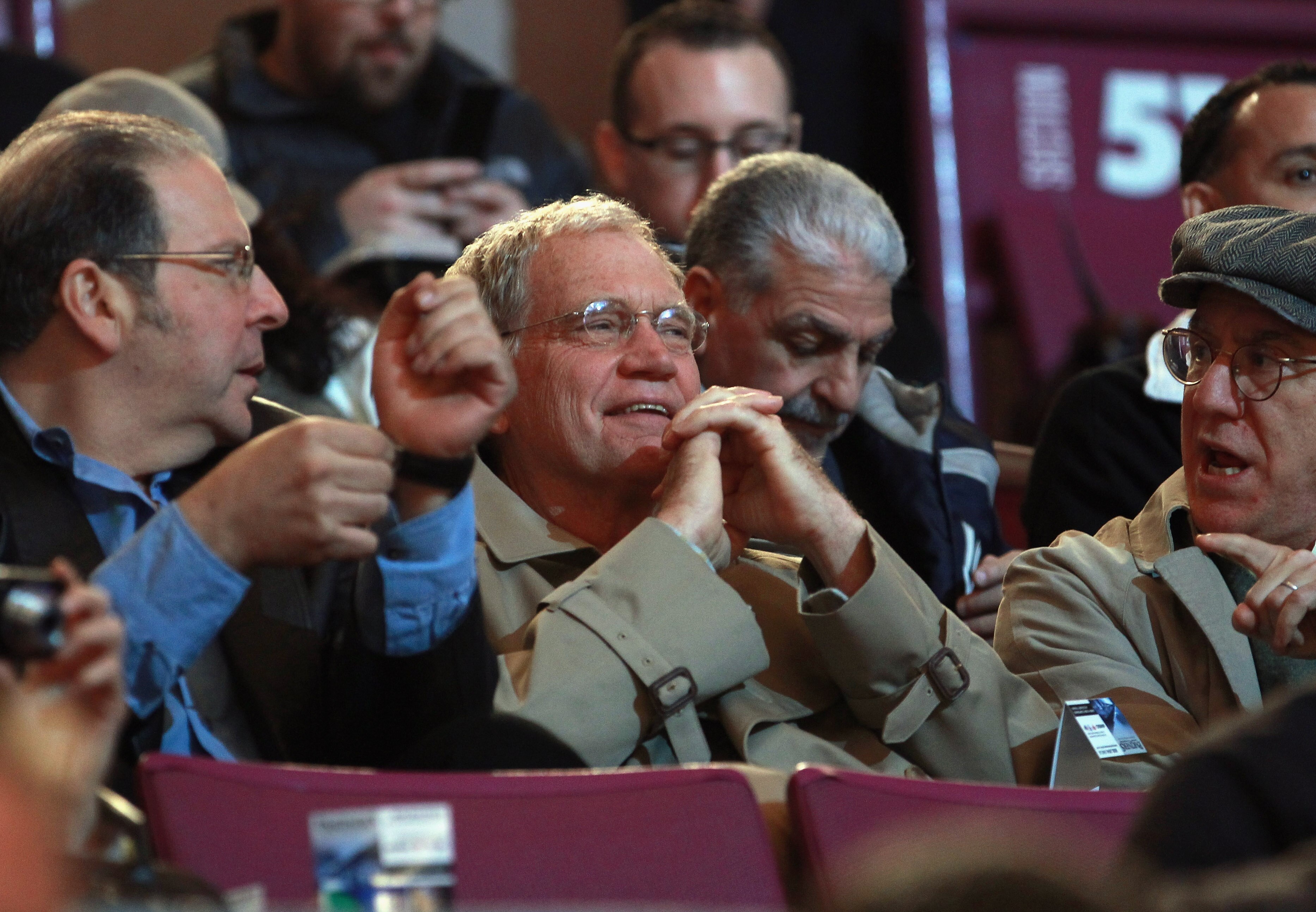 NEW YORK - NOVEMBER 11:  David Letterman (C) takes in the hockey game between the Buffalo Sabres and the New York Rangers at Madison Square Garden on November 11, 2010 in New York City.  (Photo by Bruce Bennett/Getty Images)