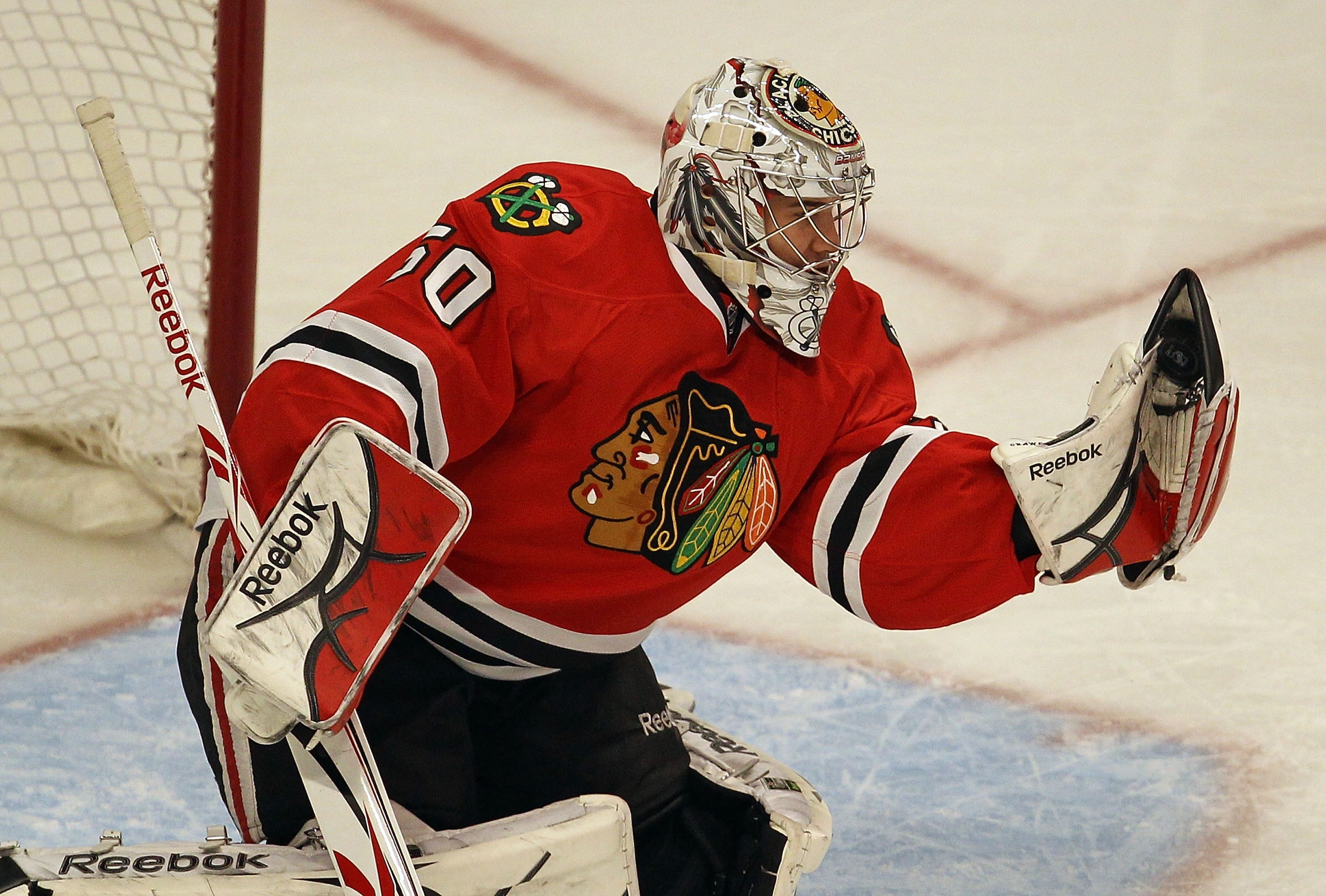 CHICAGO, IL - MARCH 23: Corey Crawford #50 of the Chicago Blackhawks makes a glove save against the Florida Panthers at the United Center on March 23, 2011 in Chicago, Illinois. (Photo by Jonathan Daniel/Getty Images)