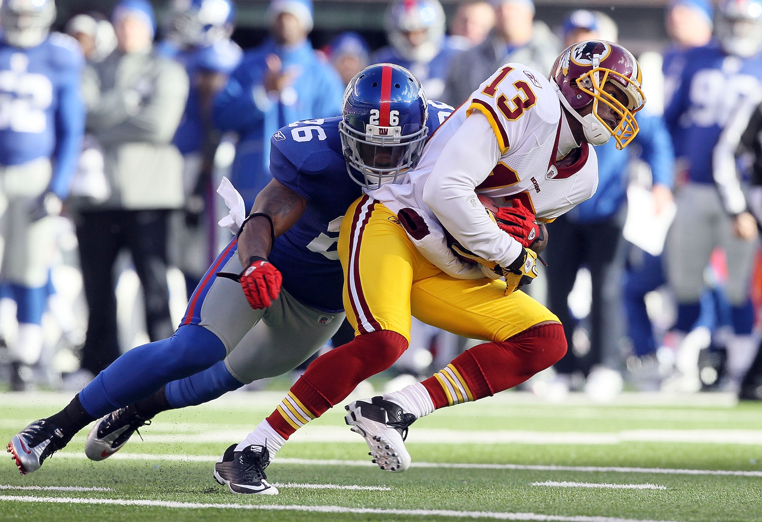 EAST RUTHERFORD, NJ - DECEMBER 05: Anthony Armstrong #13 of the Washington Redskins is tackled by Antrel Rolle #26 of the New York Giants on December 5, 2010 at the New Meadowlands Stadium in East Rutherford, New Jersey.  (Photo by Jim McIsaac/Getty Image