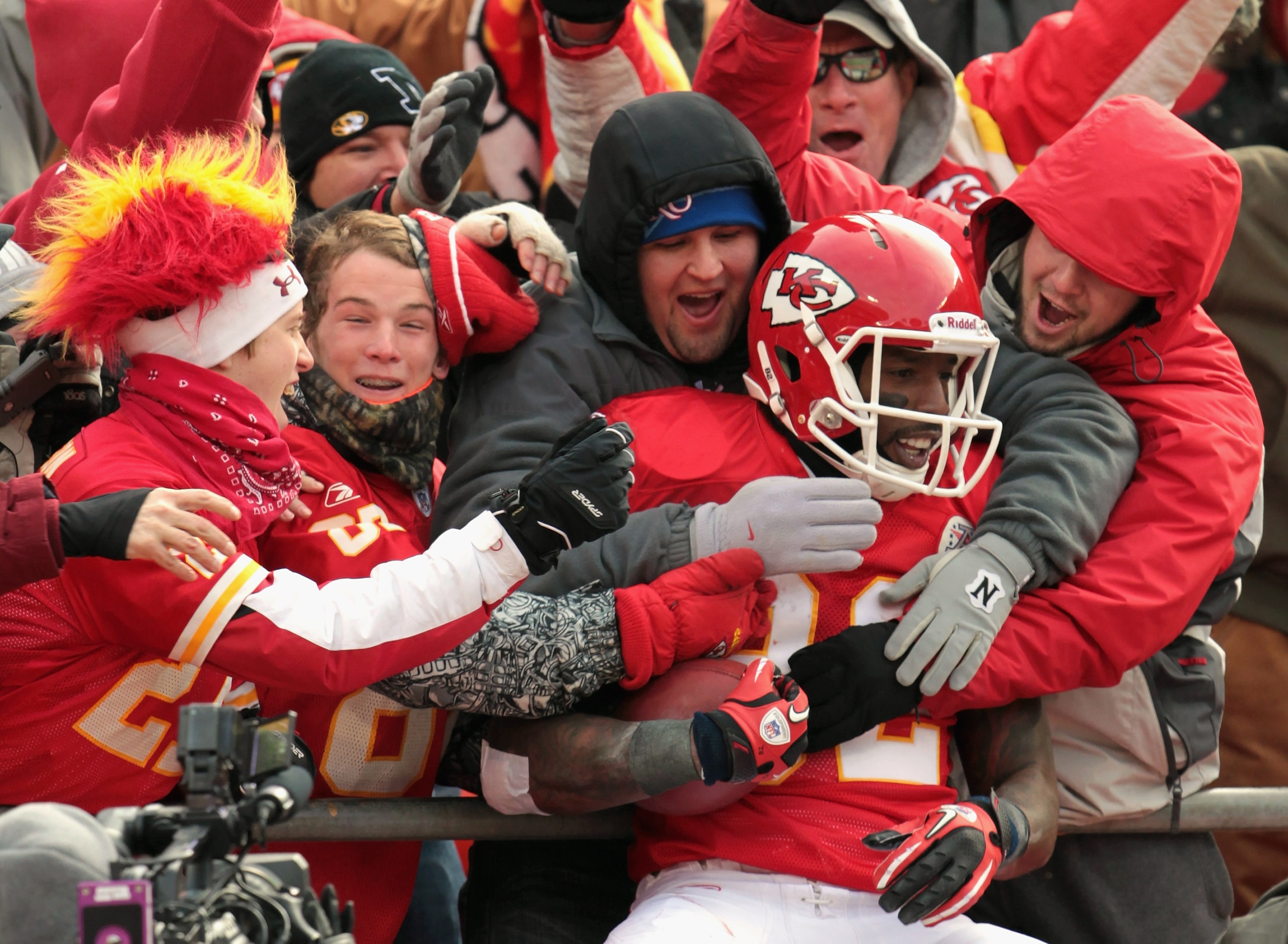 KANSAS CITY, MO - DECEMBER 26:  Receiver Dwayne Bowe #82 of the Kansas City Chiefs is congratulated by fans as he jumps into the stands after making a 75 yard touchdown catch during the game against the Tennessee Titans on December 26, 2010 at Arrowhead S