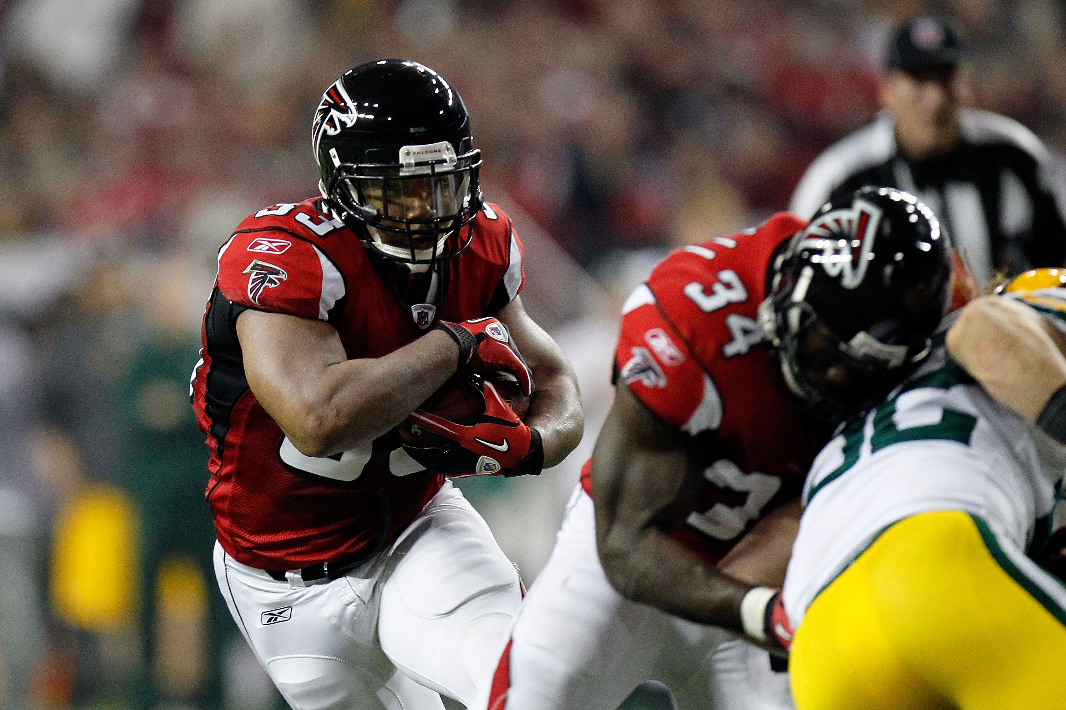 Atlanta Falcons running back Michael Turner (33) runs past San Diego  Chargers Steve Gregory (28) during their NFL pre-season game against the  San Diego Chargers at the Georgia Dome in Atlanta Saturday