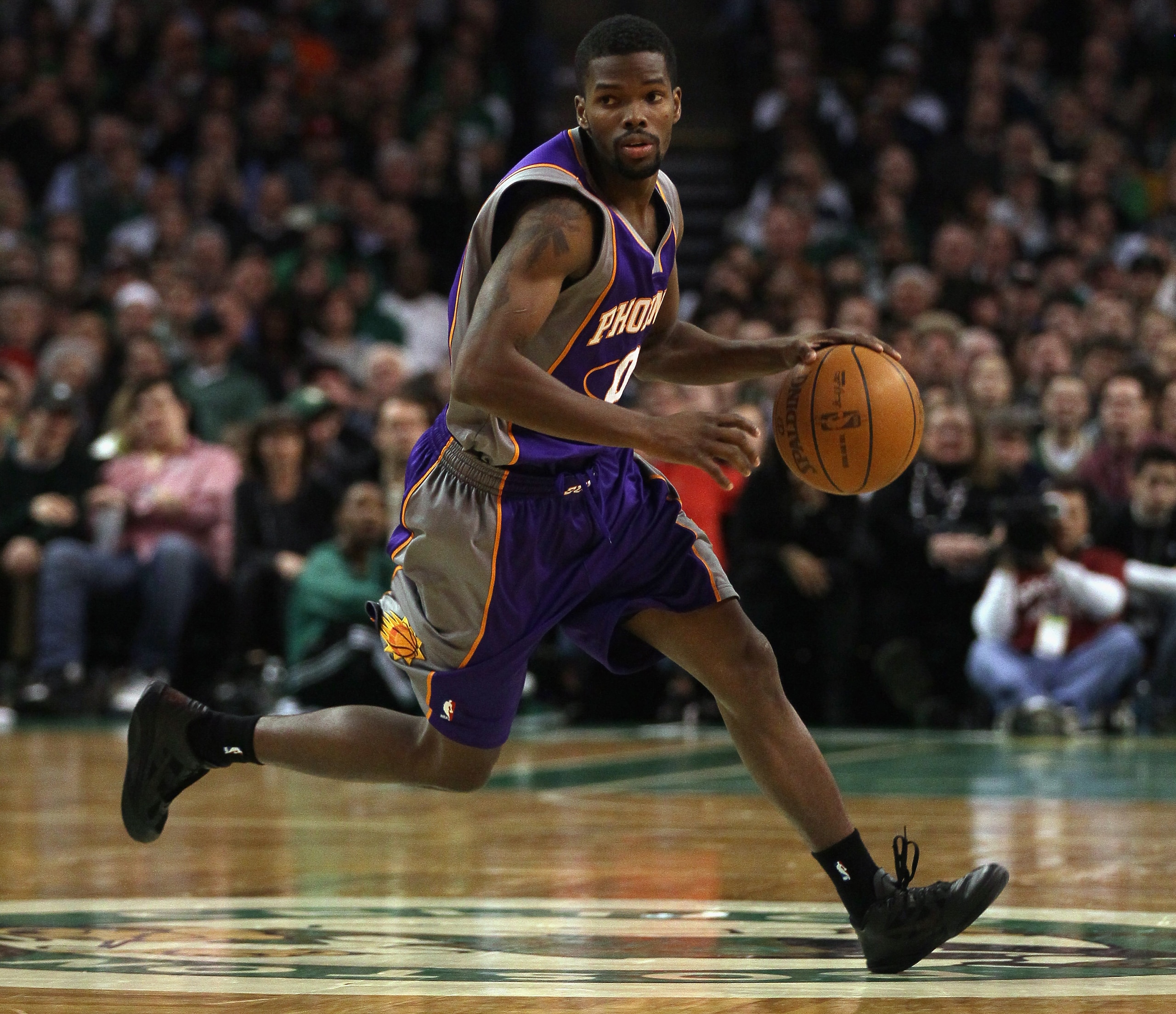 BOSTON, MA - MARCH 02:  Aaron Brooks #0 of the Phoenix Suns heads up the court in the second half against the Boston Celtics on March 2, 2011 at the TD Garden in Boston, Massachusetts.  The Celtics defeated the Suns 115-103. NOTE TO USER: User expressly a
