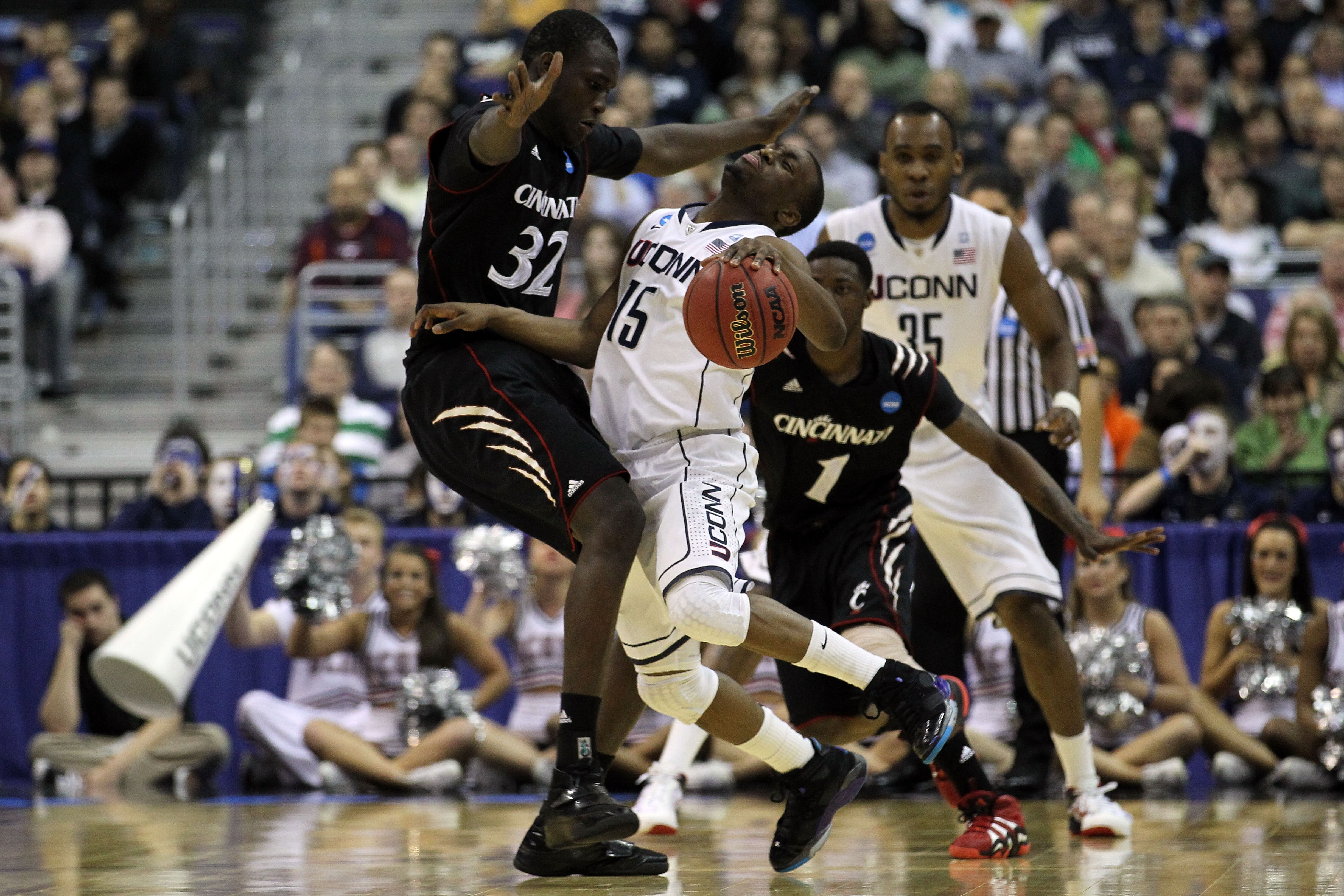 WASHINGTON - MARCH 19:  Kemba Walker #15 of the Connecticut Huskies collides with Ibrahima Thomas #32 of the Cincinnati Bearcats during the third round of the 2011 NCAA men's basketball tournament at Verizon Center on March 19, 2011 in Washington, DC.  (P