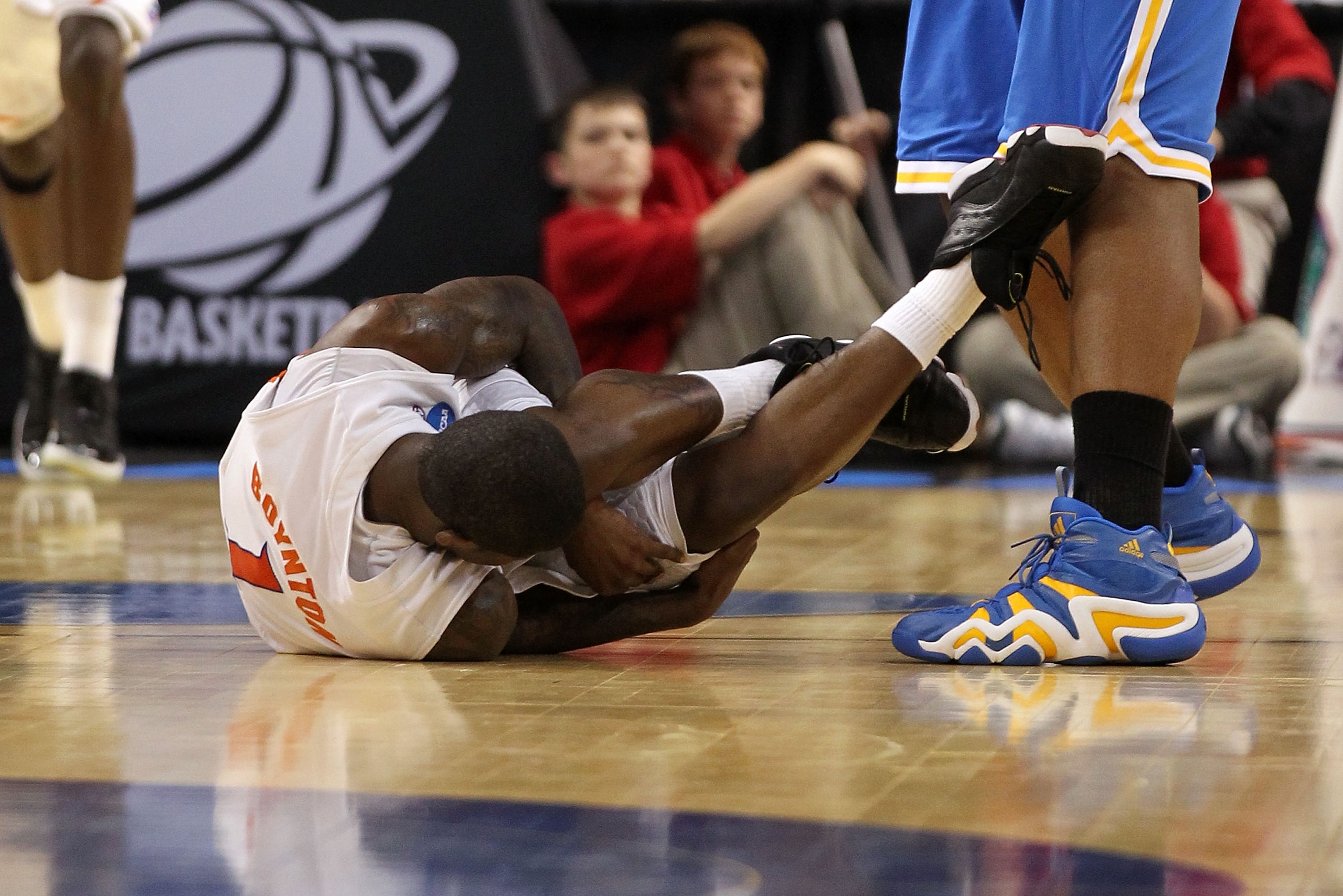 TAMPA, FL - MARCH 19: Kenny Boynton #1 of the Florida Gators lies on the court in pain after he was injured against the UCLA Bruins during the third round of the 2011 NCAA men's basketball tournament at St. Pete Times Forum on March 19, 2011 in Tampa, Fl TAMPA, FL - MARCH 19: Kenny Boynton #1 of the Florida Gators lies on the court in pain after he was injured against the UCLA Bruins during the third round of the 2011 NCAA men's basketball tournament at St. Pete Times Forum on March 19, 2011 in Tampa, Fl
