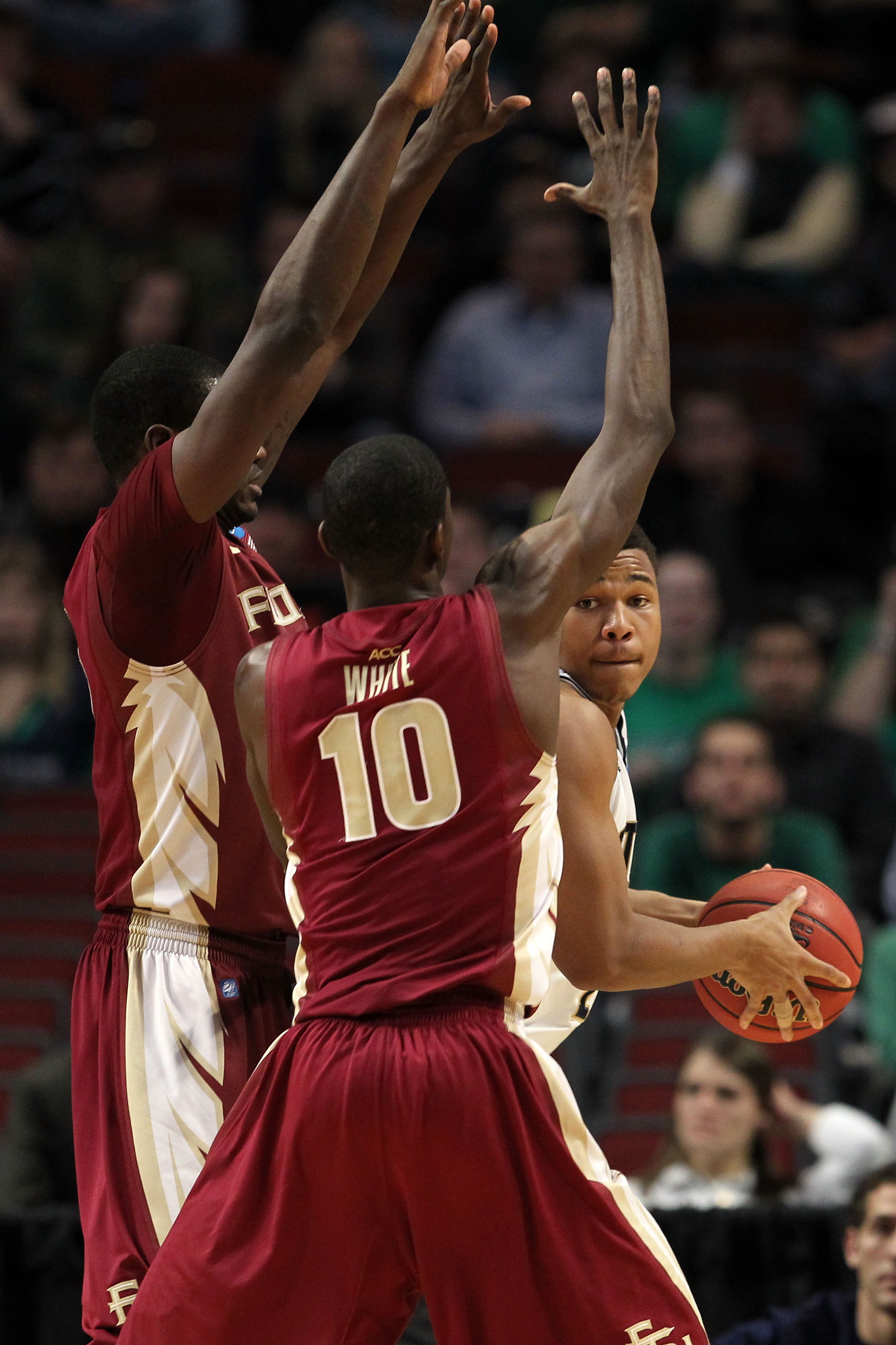 CHICAGO, IL - MARCH 20:  Tyrone Nash #1 of the Notre Dame Fighting Irish looks to pass against Okaro White #10 of the Florida State Seminoles in the second half during the third round of the 2011 NCAA men's basketball tournament at the United Center on Ma