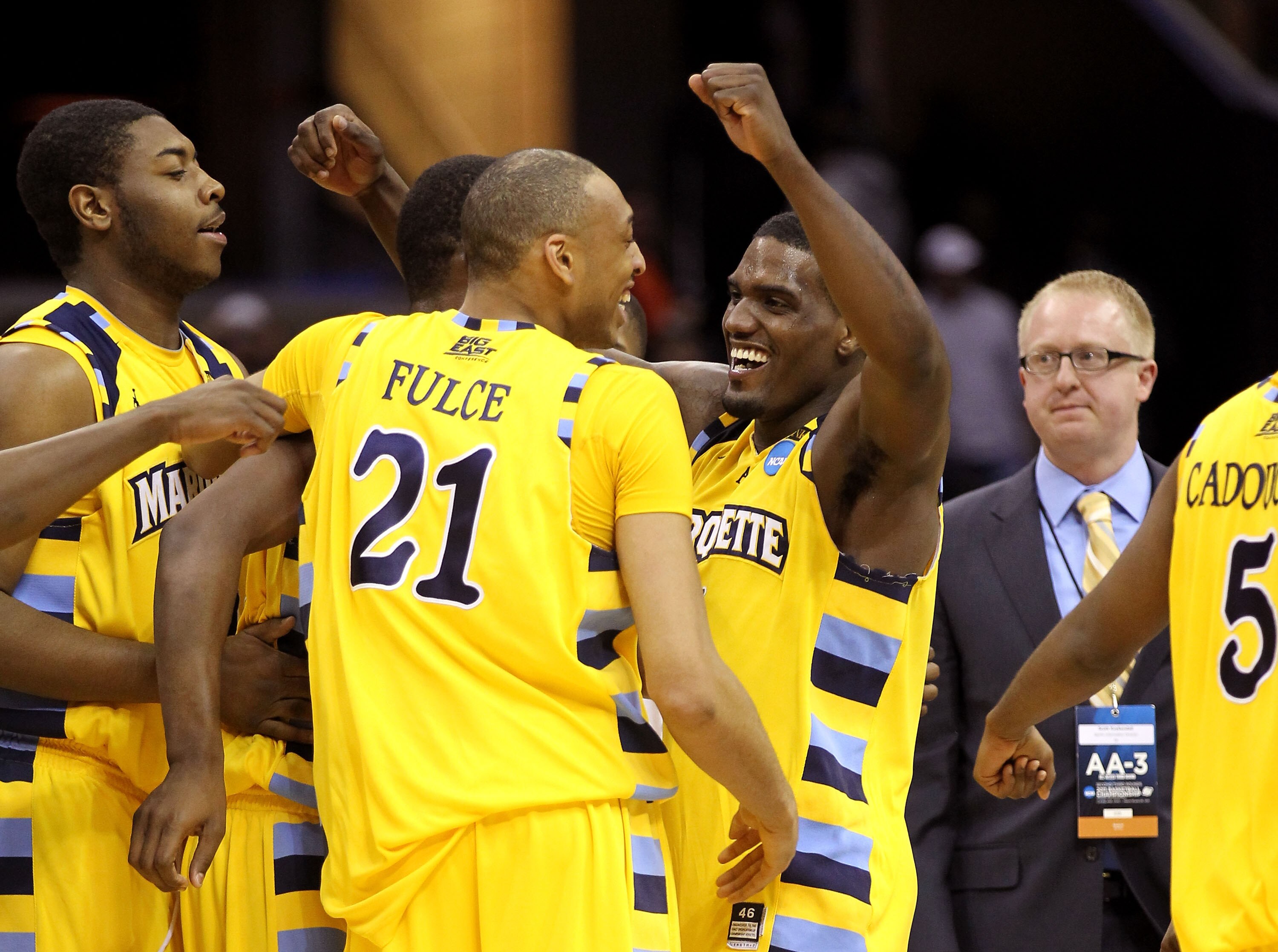 CLEVELAND, OH - MARCH 20: Joseph Fulce #21 and Darius Johnson-Odom #1 of the Marquette Golden Eagles celebrate with teammates after defeating the Syracuse Orange during the third of the 2011 NCAA men's basketball tournament at Quicken Loans Arena on March