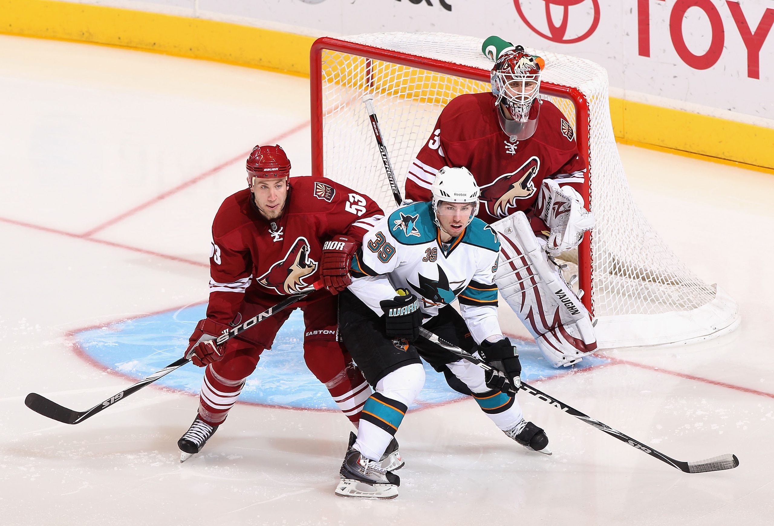 GLENDALE, AZ - JANUARY 17:  Logan Couture #39 of the San Jose Sharks fights for position with Derek Morris #53 of the Phoenix Coyotes during the NHL game at Jobing.com Arena on January 17, 2011 in Glendale, Arizona.  The Sharks defeated the Coyotes 4-2.