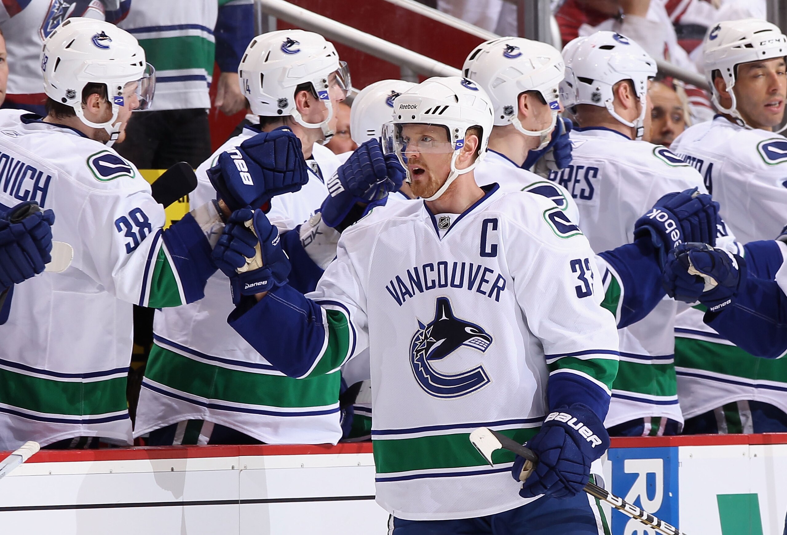 GLENDALE, AZ - MARCH 08:  Henrik Sedin #33 of the Vancouver Canucks celebrates with teammates on the bench after scoring a second period goal against the Phoenix Coyotes during the NHL game at Jobing.com Arena on March 8, 2011 in Glendale, Arizona.  (Phot