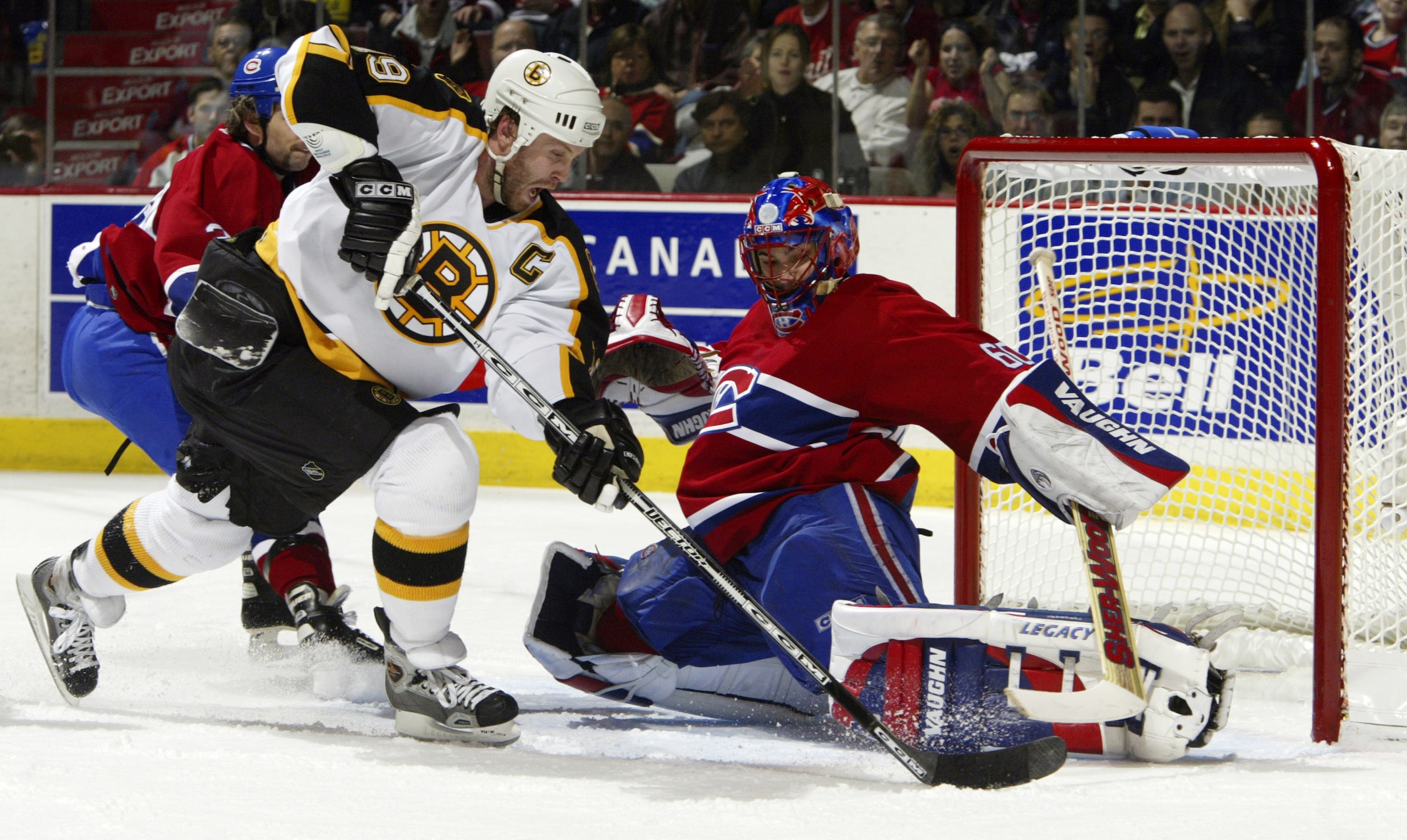 MONTREAL, CAN - APRIL 17:  Jose Theodore #60 of the Montreal Canadiens makes a pad save against Joe Thornton #19 of the Boston Bruins during game six of the Eastern Conference Quarterfinals at Bell Centre on April 17, 2004 in Montreal, Canada.  (Photo by