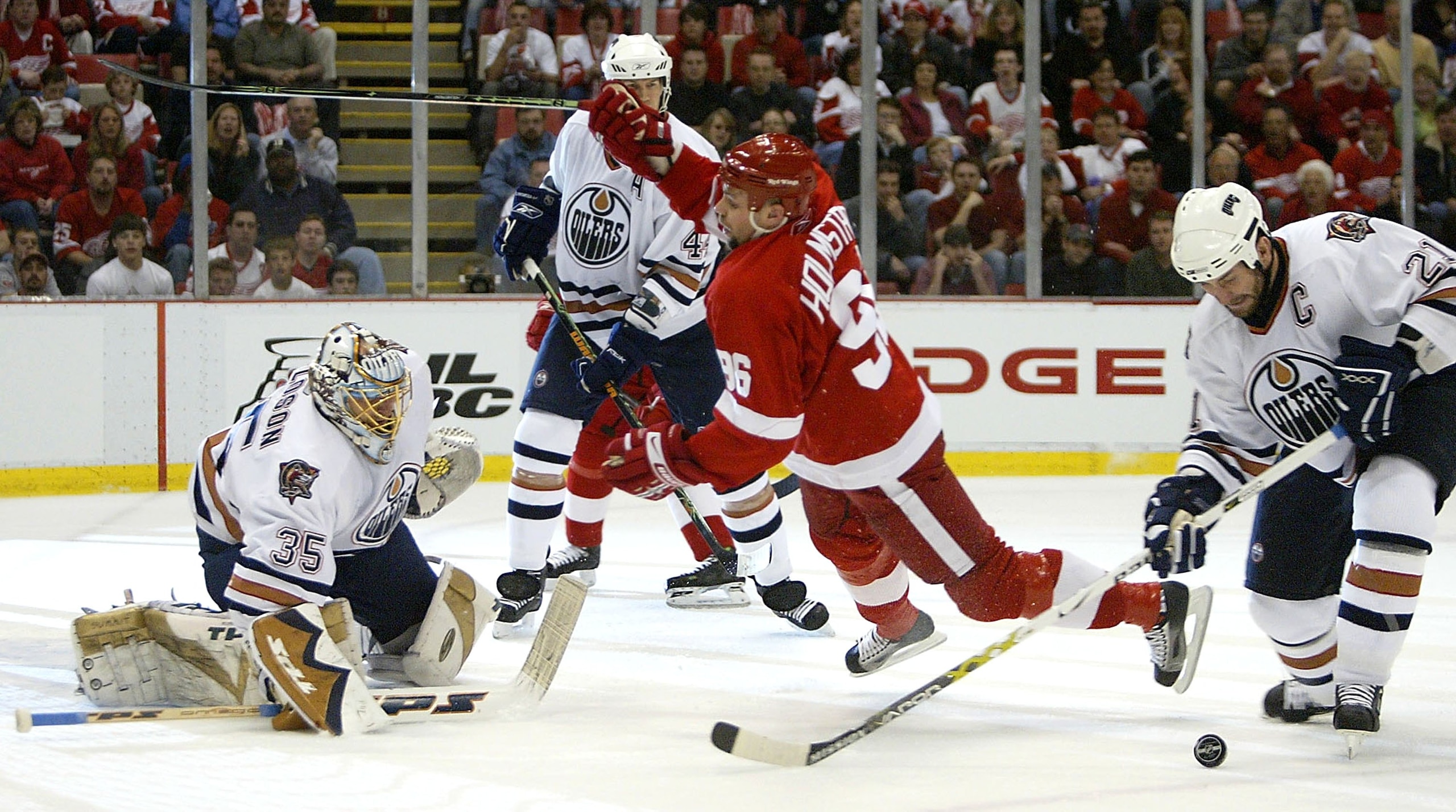 DETROIT - APRIL 23:  Dwayne Roloson #35 of the Edmonton Oilers gets set to make a save as teammates Chris Pronger #44, Jason Smith #21 and Tomas Holmstrom #96 of the Detroit Red Wings battle for position in game two of the Western Conference Quarterfinals