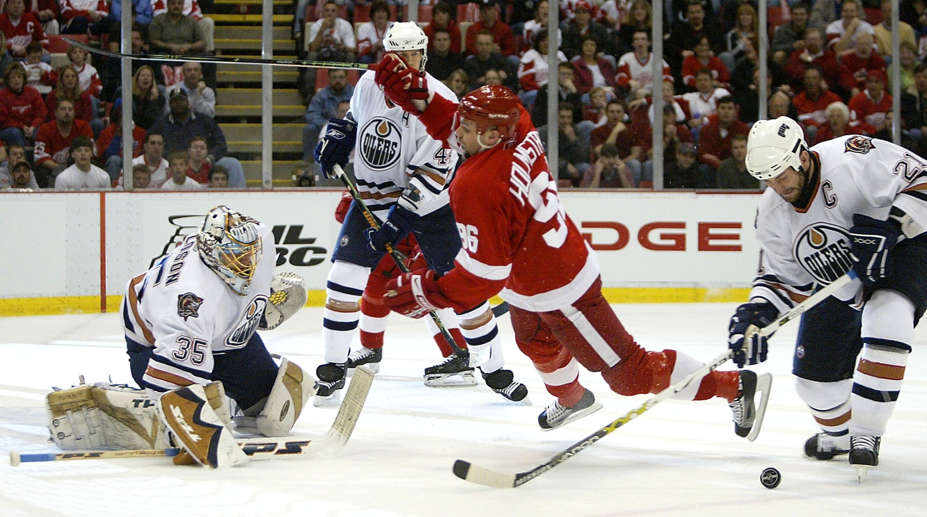 DETROIT - APRIL 23:  Dwayne Roloson #35 of the Edmonton Oilers gets set to make a save as teammates Chris Pronger #44, Jason Smith #21 and Tomas Holmstrom #96 of the Detroit Red Wings battle for position in game two of the Western Conference Quarterfinals