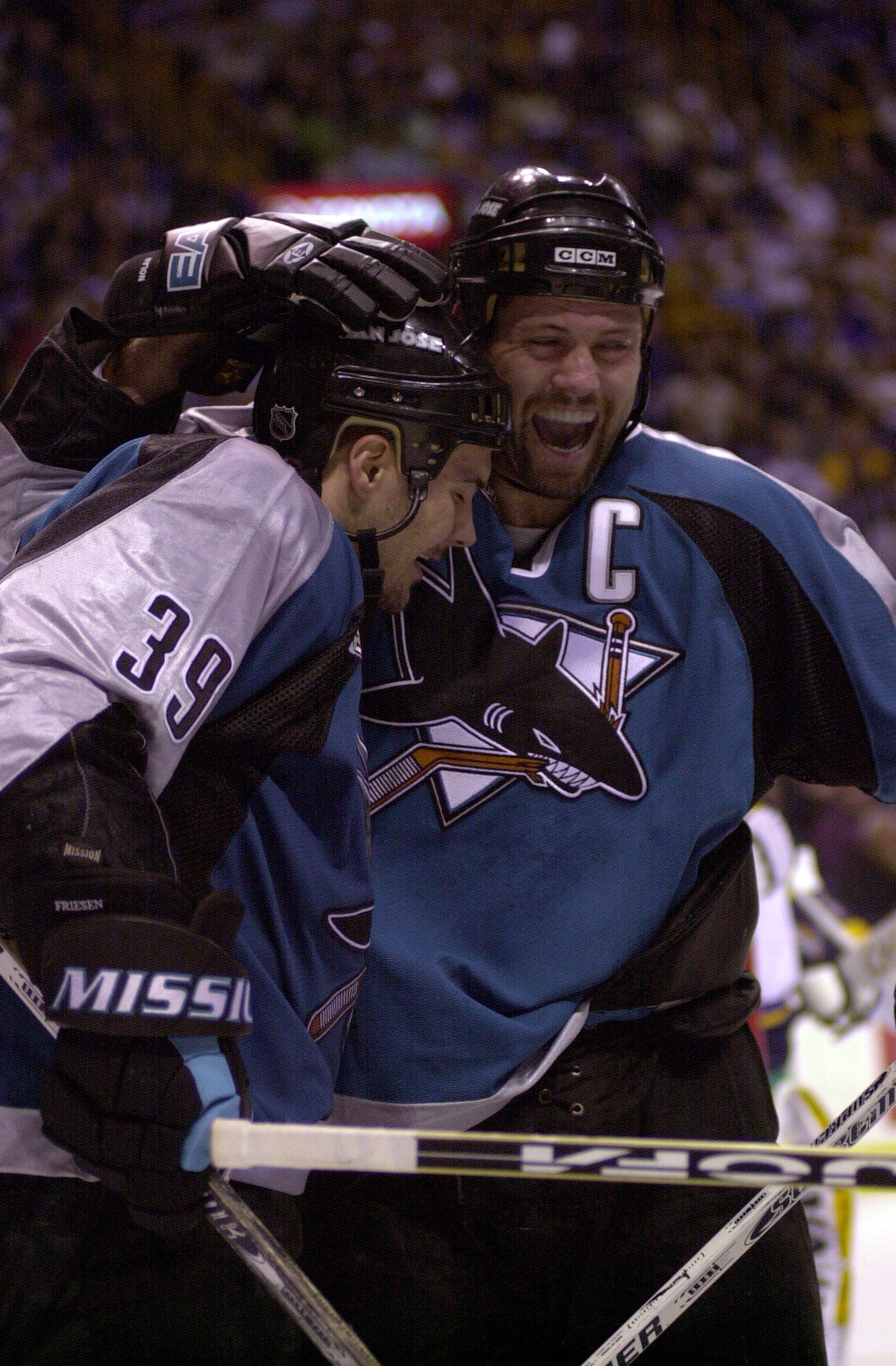 25 Apr 2000: Owen Nolan #11 congratulates Jeff Friesen #39 of the San Jose Sharks after Friesen scored the third goal for the sharks during the second period against the St. Louis Blues during the first round of the NHL Stanley Cup Playoffs at the Kiel Ce