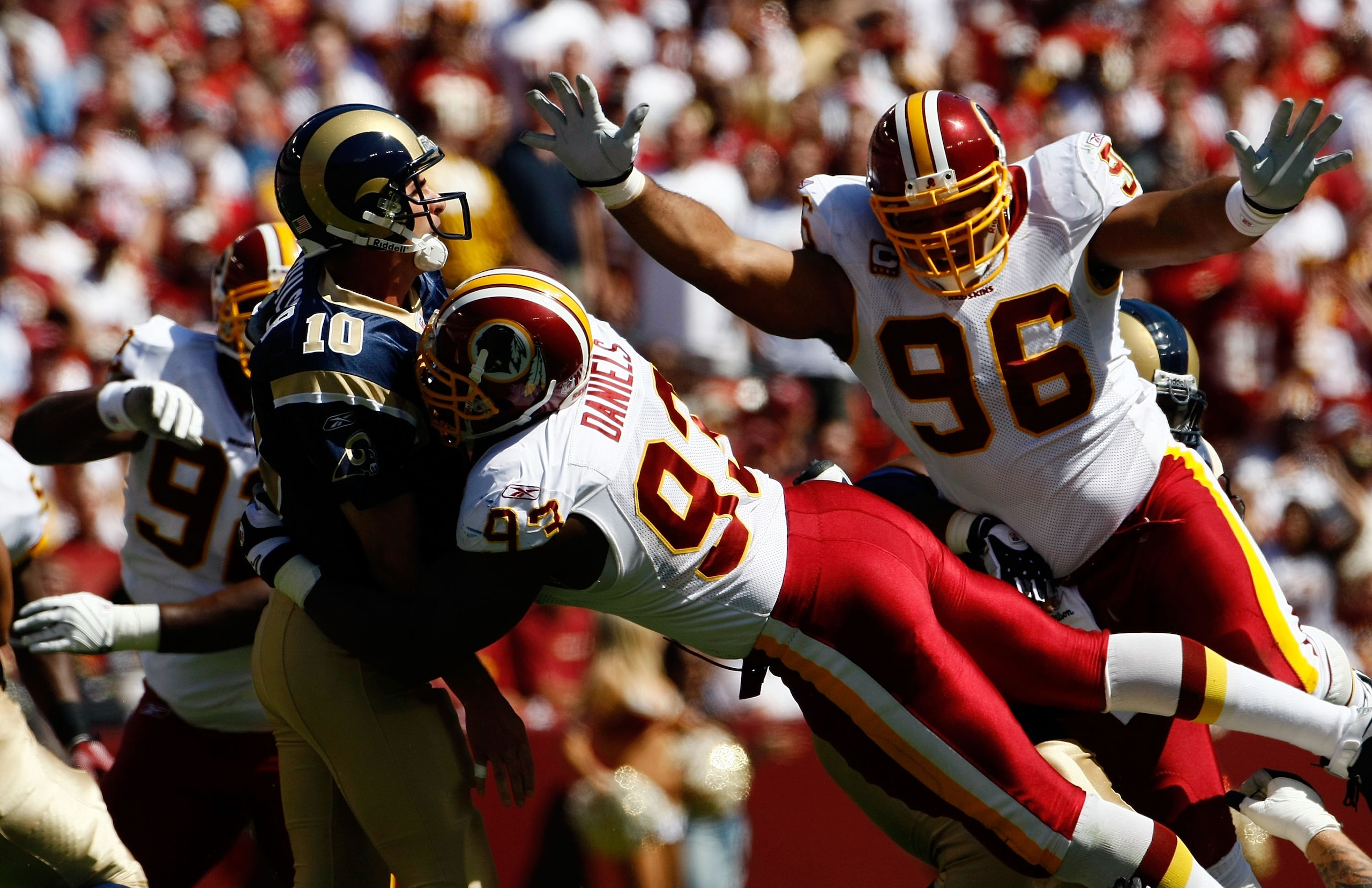 LANDOVER, MD - SEPTEMBER 20:  Mark Bulger #10 of the St. Louis Rams tries to avoid Phillip Daniels #92 and Cornelius Griffin #96 of the Washington Redskins during their game on September 20, 2009 at FedEx Field in Landover, Maryland.  (Photo by Win McName