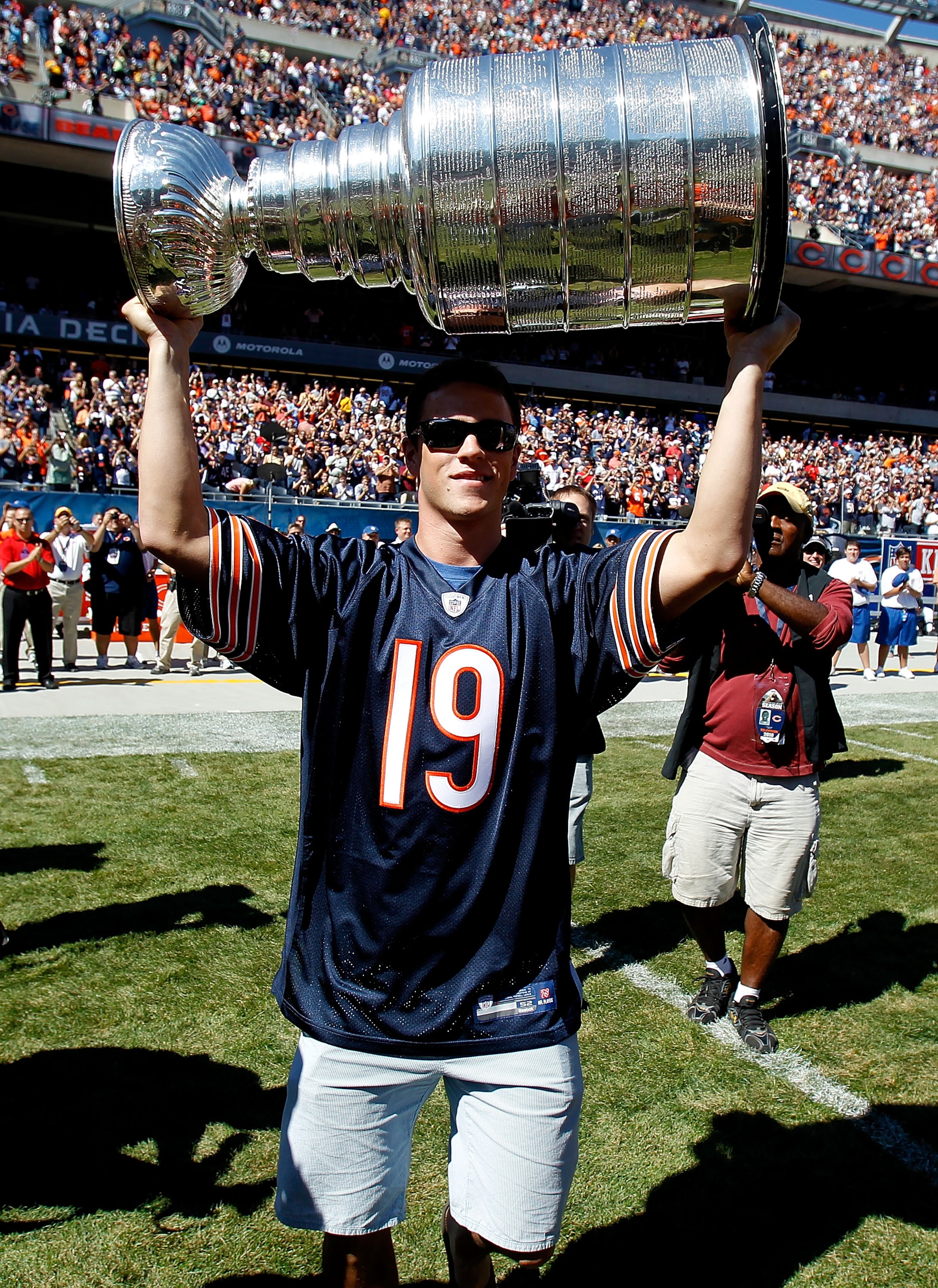 CHICAGO - SEPTEMBER 12: Jonathan Toews of the Chicago Blackhawks carries the Stanley Cup to the field before the NFL opening season game between  the Chicago Bears and the Detroit Lions at Soldier Field on September 12, 2010 in Chicago, Illinois.  The Bea