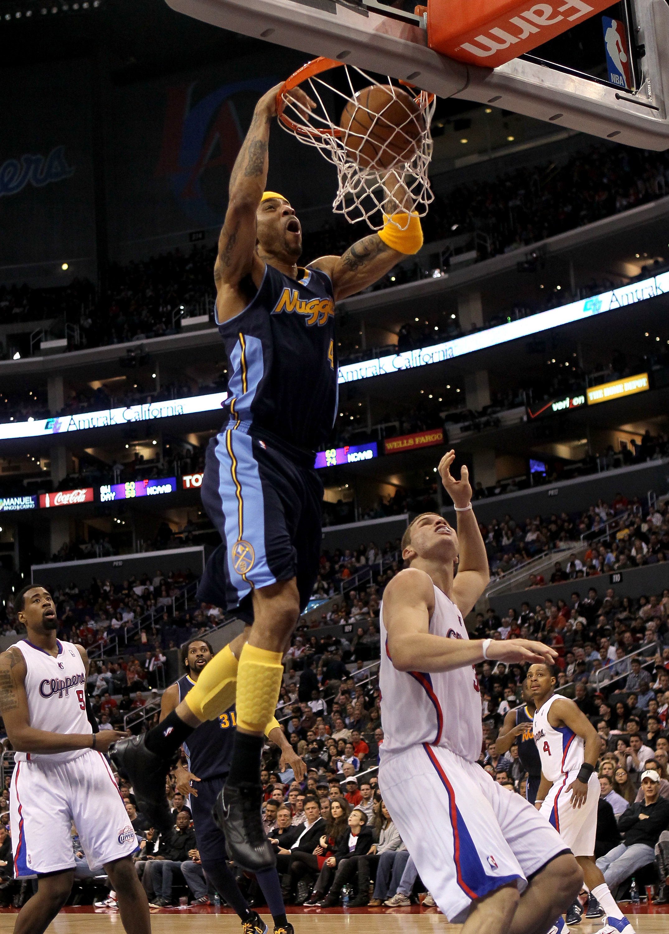 LOS ANGELES, CA - MARCH 5:  Kenyon Martin #4 of the Denver Nuggets dunks over Blake Griffin #32 of the Los Angeles Clippers at Staples Center on March 5, 2011 in Los Angeles, California. The Clippers won 100-94. NOTE TO USER: User expressly acknowledges a