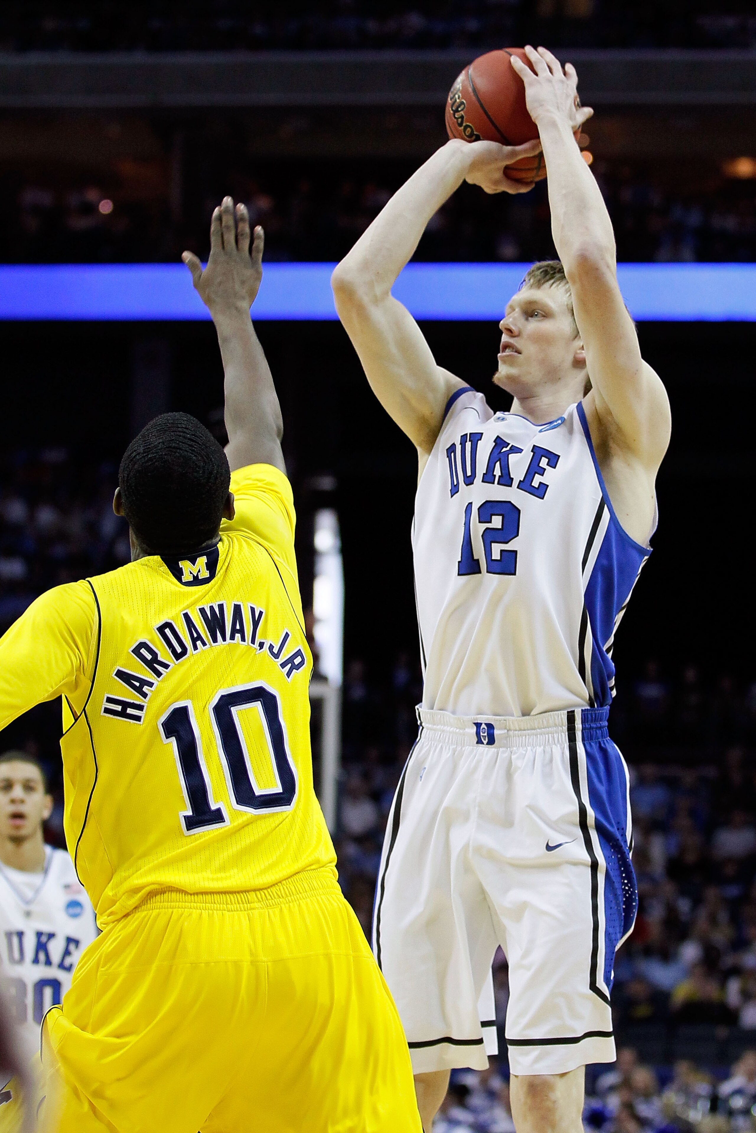 CHARLOTTE, NC - MARCH 20:  Kyle Singler #12 of the Duke Blue Devils shoots over Tim Hardaway Jr. #10 of the Michigan Wolverines during the third round of the 2011 NCAA men's basketball tournament at Time Warner Cable Arena on March 20, 2011 in Charlotte,
