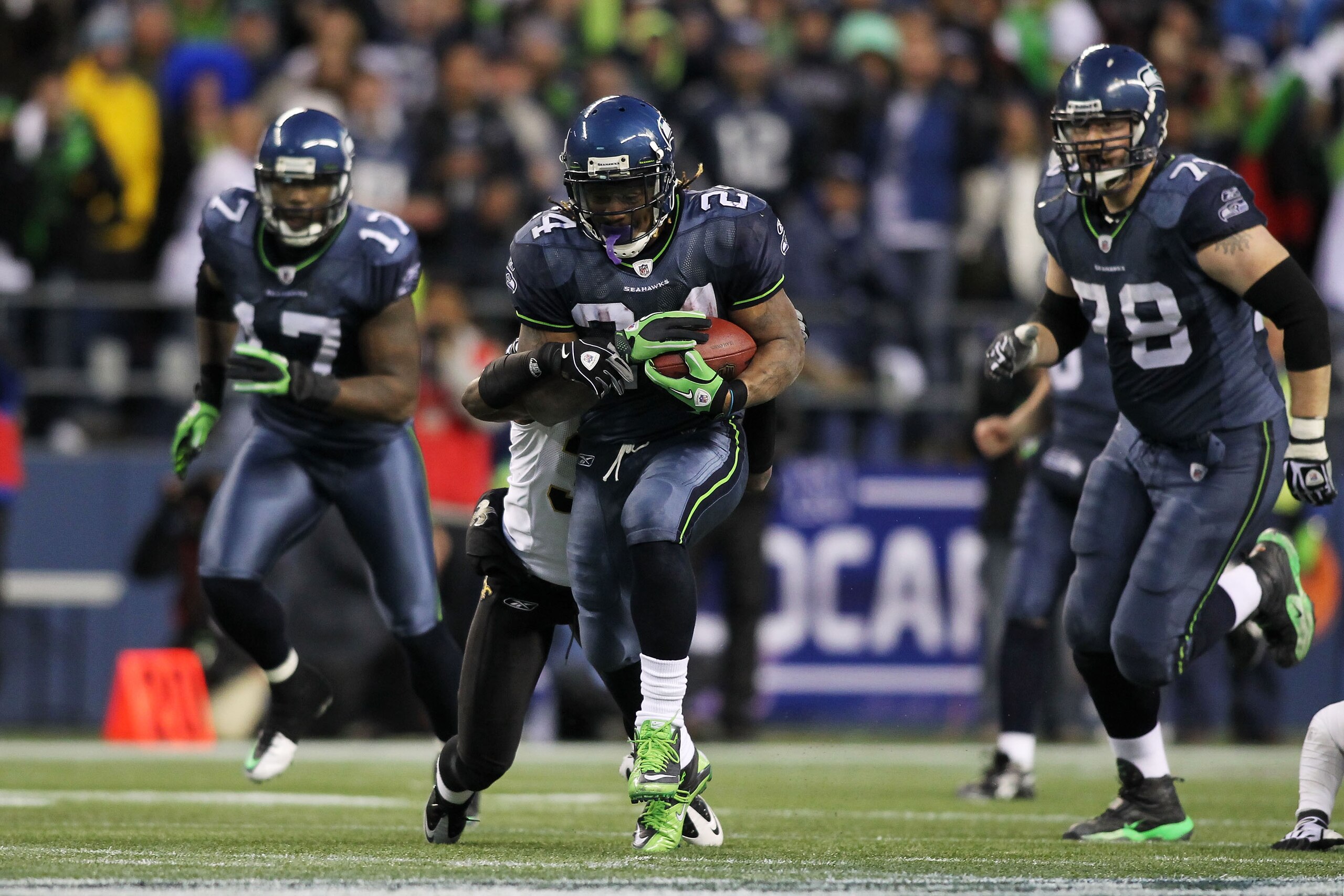 SEATTLE, WA - JANUARY 08: Running back Marshawn Lynch #24 of the Seattle Seahawks runs for a 67-yard touchdown in the fourth quarter against the New Orleans Saints during the 2011 NFC wild-card playoff game at Qwest Field on January 8, 2011 in Seattle, W SEATTLE, WA - JANUARY 08: Running back Marshawn Lynch #24 of the Seattle Seahawks runs for a 67-yard touchdown in the fourth quarter against the New Orleans Saints during the 2011 NFC wild-card playoff game at Qwest Field on January 8, 2011 in Seattle, W