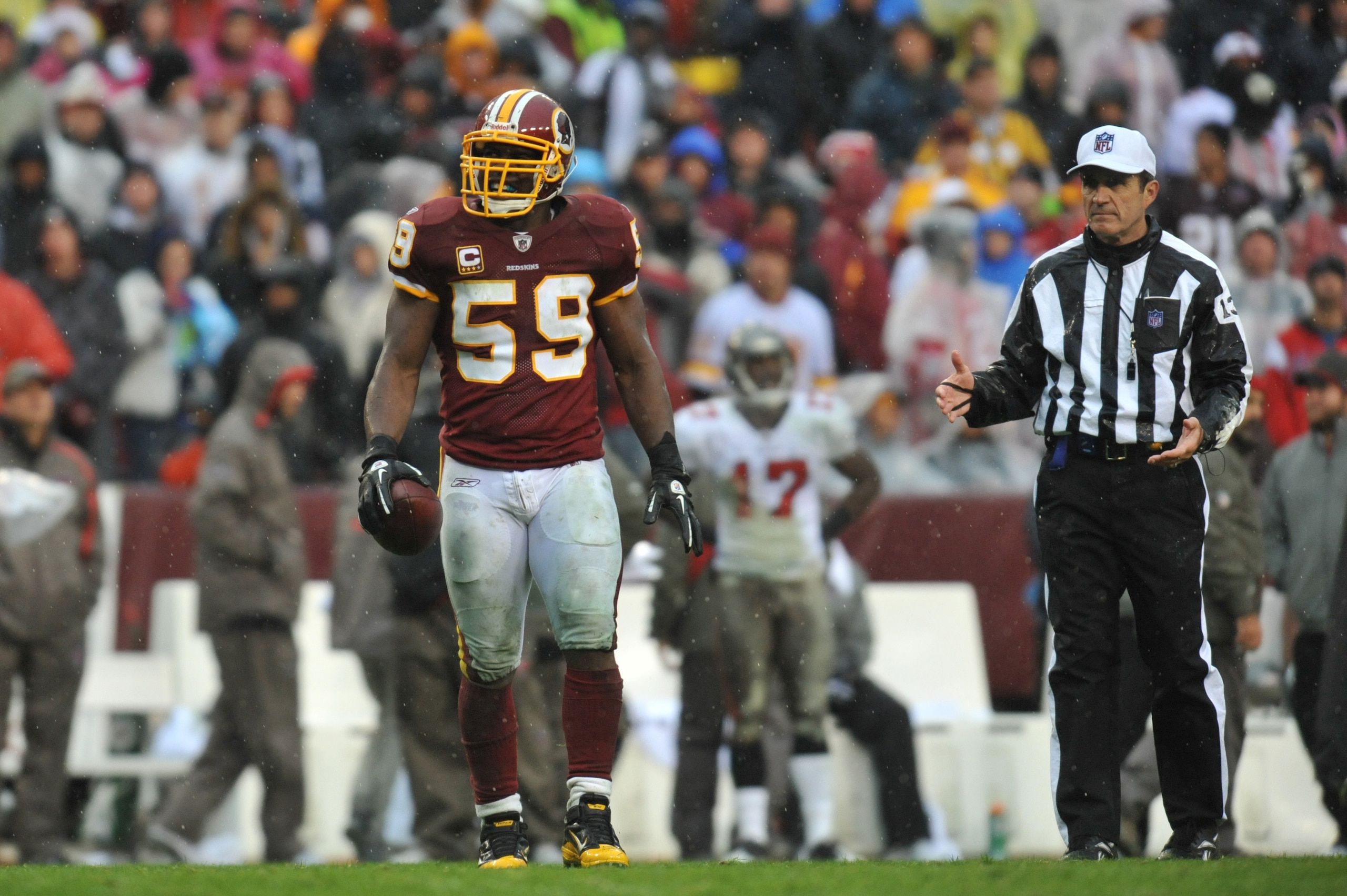 LANDOVER, MD - DECEMBER 12:  London Fletcher #59 of the Washington Redskins holds onto the ball after a fumble recovery against the Tampa Bay Buccaneers  at FedExField on December 12, 2010 in Landover, Maryland. The Buccaneers defeated the Redskins 17-16.
