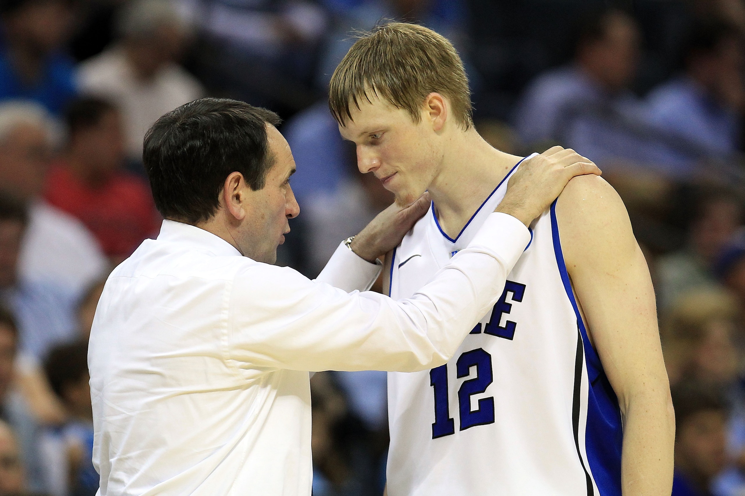 CHARLOTTE, NC - MARCH 20:  Head coach Mike Krzyzewski of the Duke Blue Devils talks with Kyle Singler #12 while taking on the Michigan Wolverines during the third round of the 2011 NCAA men's basketball tournament at Time Warner Cable Arena on March 20, 2