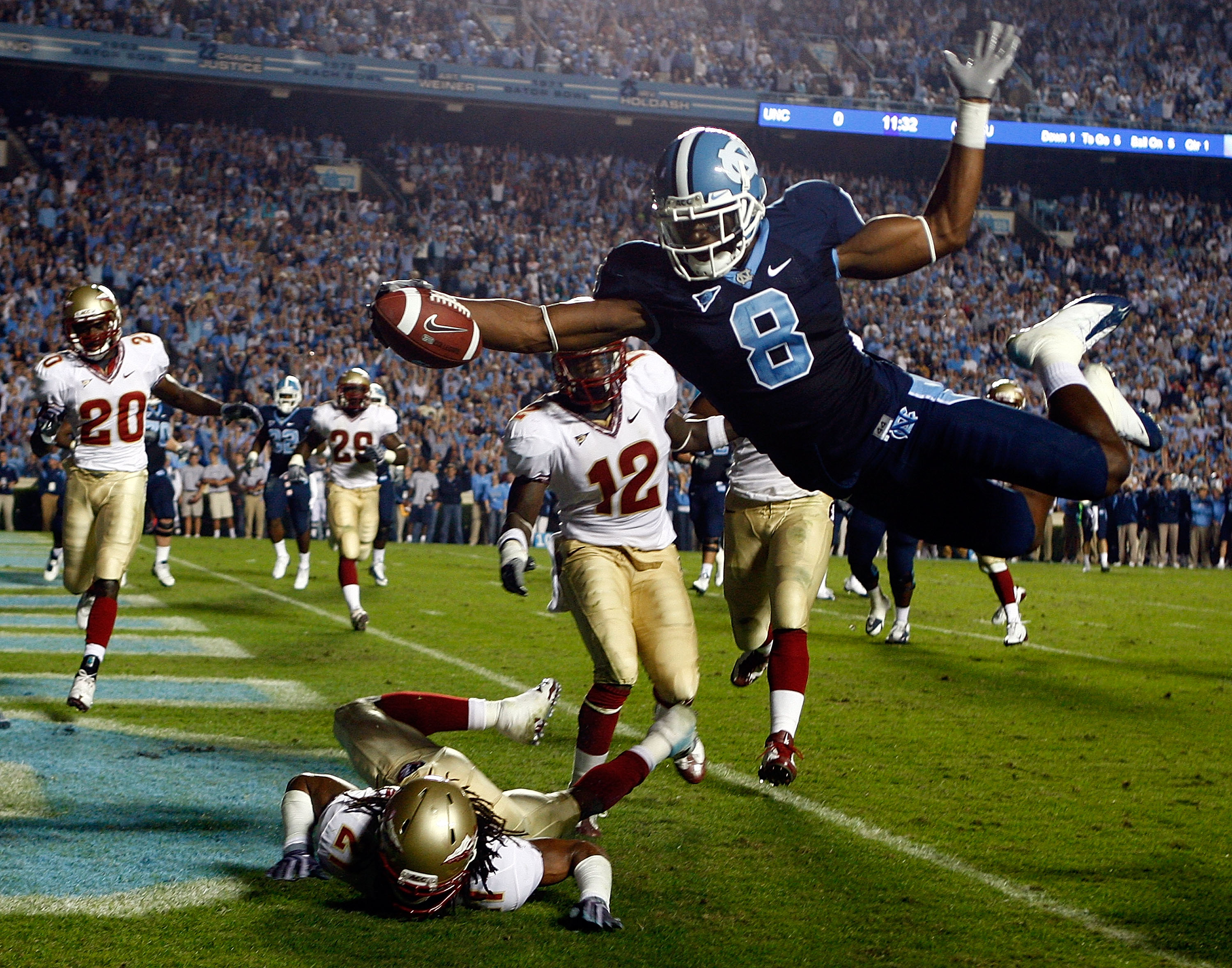 CHAPEL HILL, NC - OCTOBER 22: Greg Little #8 of the North Carolina Tar Heels dives past Florida State Seminole defenders Patrick Robinson #21 and Nigel Carr #12 for a first quarter touchdown at Kenan Stadium on October 22, 2009 in Chapel Hill, North Caro CHAPEL HILL, NC - OCTOBER 22: Greg Little #8 of the North Carolina Tar Heels dives past Florida State Seminole defenders Patrick Robinson #21 and Nigel Carr #12 for a first quarter touchdown at Kenan Stadium on October 22, 2009 in Chapel Hill, North Caro