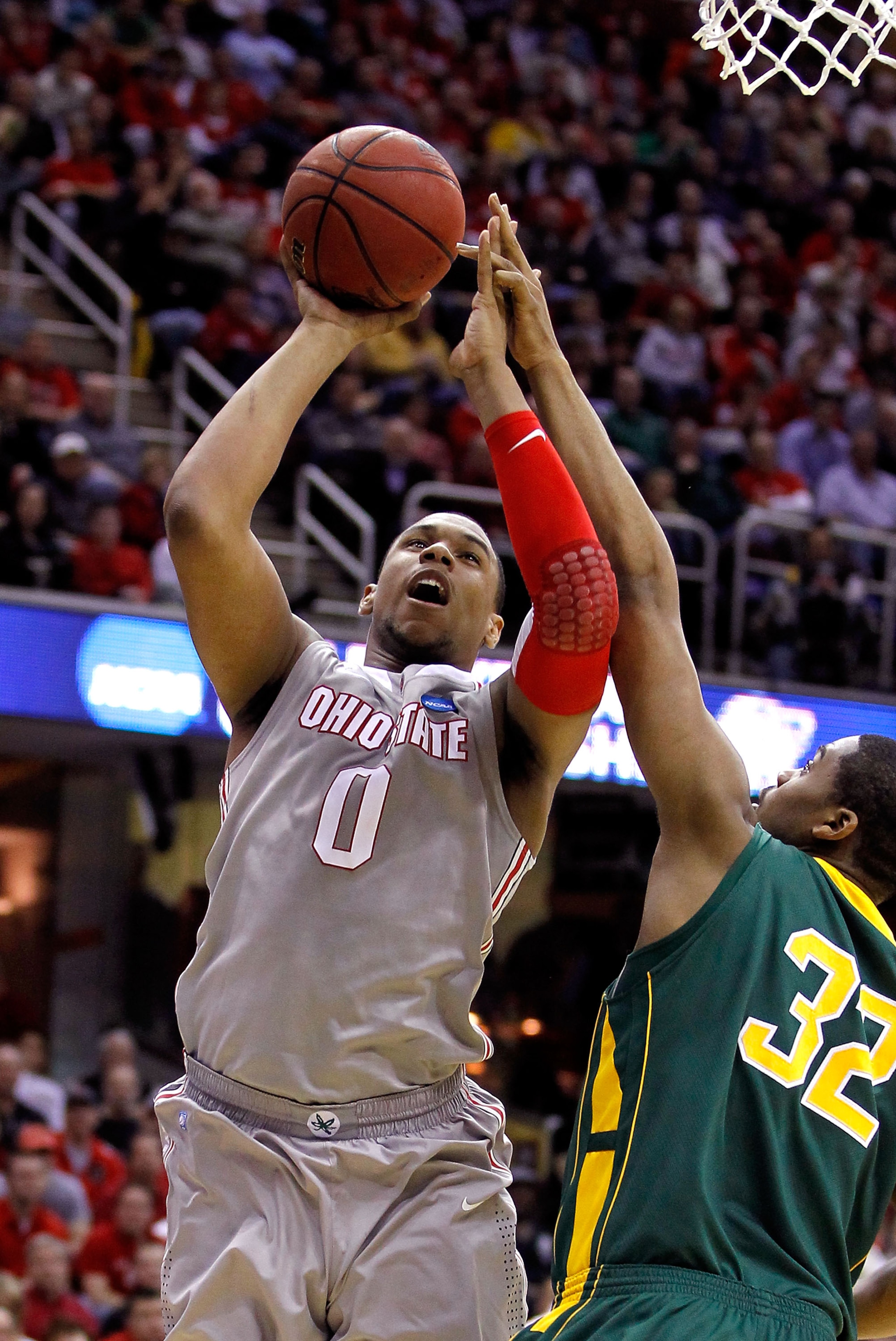 CLEVELAND, OH - MARCH 20: Jared Sullinger #0 of the Ohio State Buckeyes drives to the basket against Johnny Williams #32 of the George Mason Patriots during the third of the 2011 NCAA men's basketball tournament at Quicken Loans Arena on March 20, 2011 in
