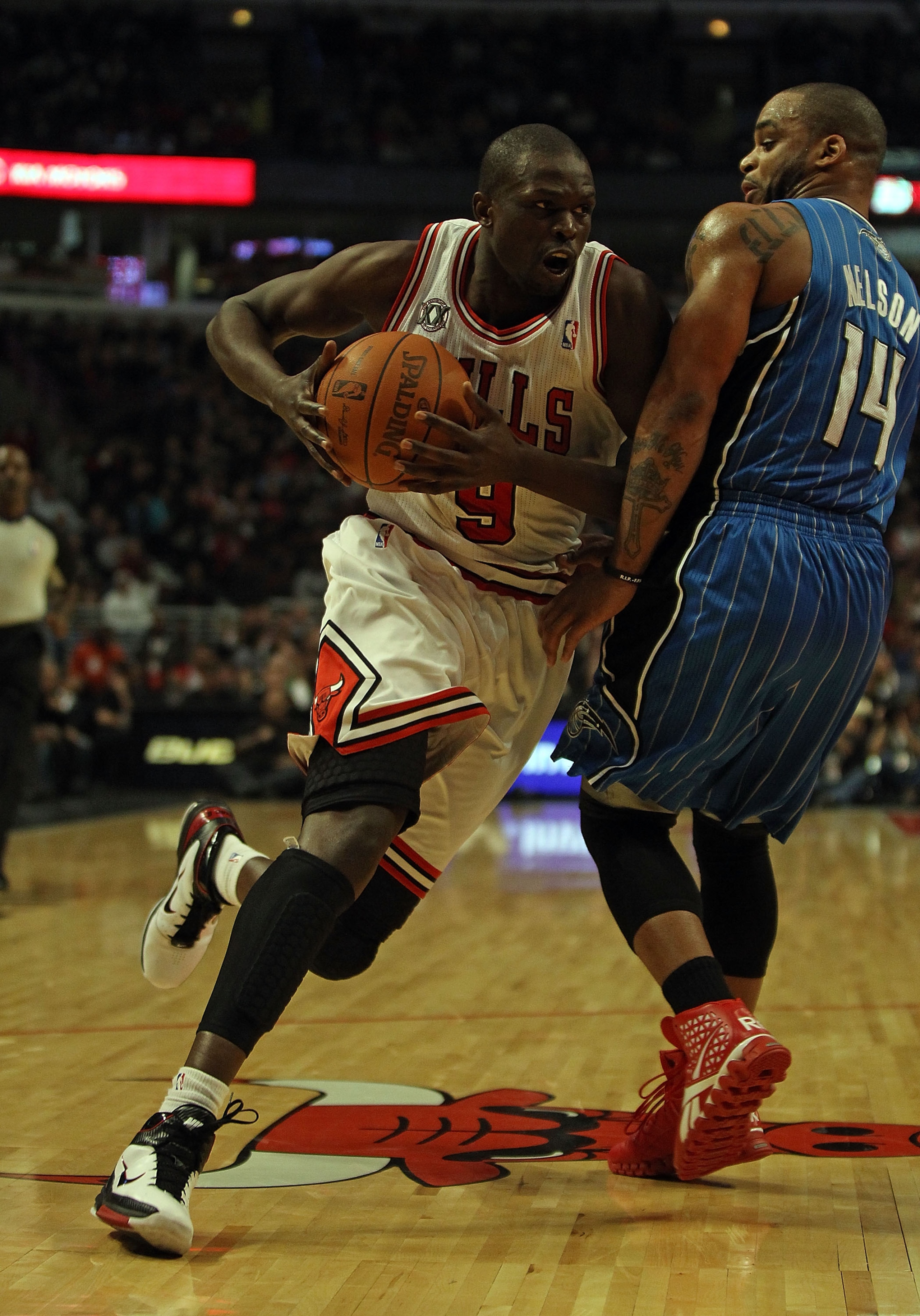 CHICAGO, IL - DECEMBER 01: Loul Deng #9 of the Chicago Bulls drives against Jameer Nelson #14 of the Orlando Magic at the United Center on December 1, 2010 in Chicago, Illinois. The Magic defeated the Bulls 107-78. NOTE TO USER: User expressly acknowledge