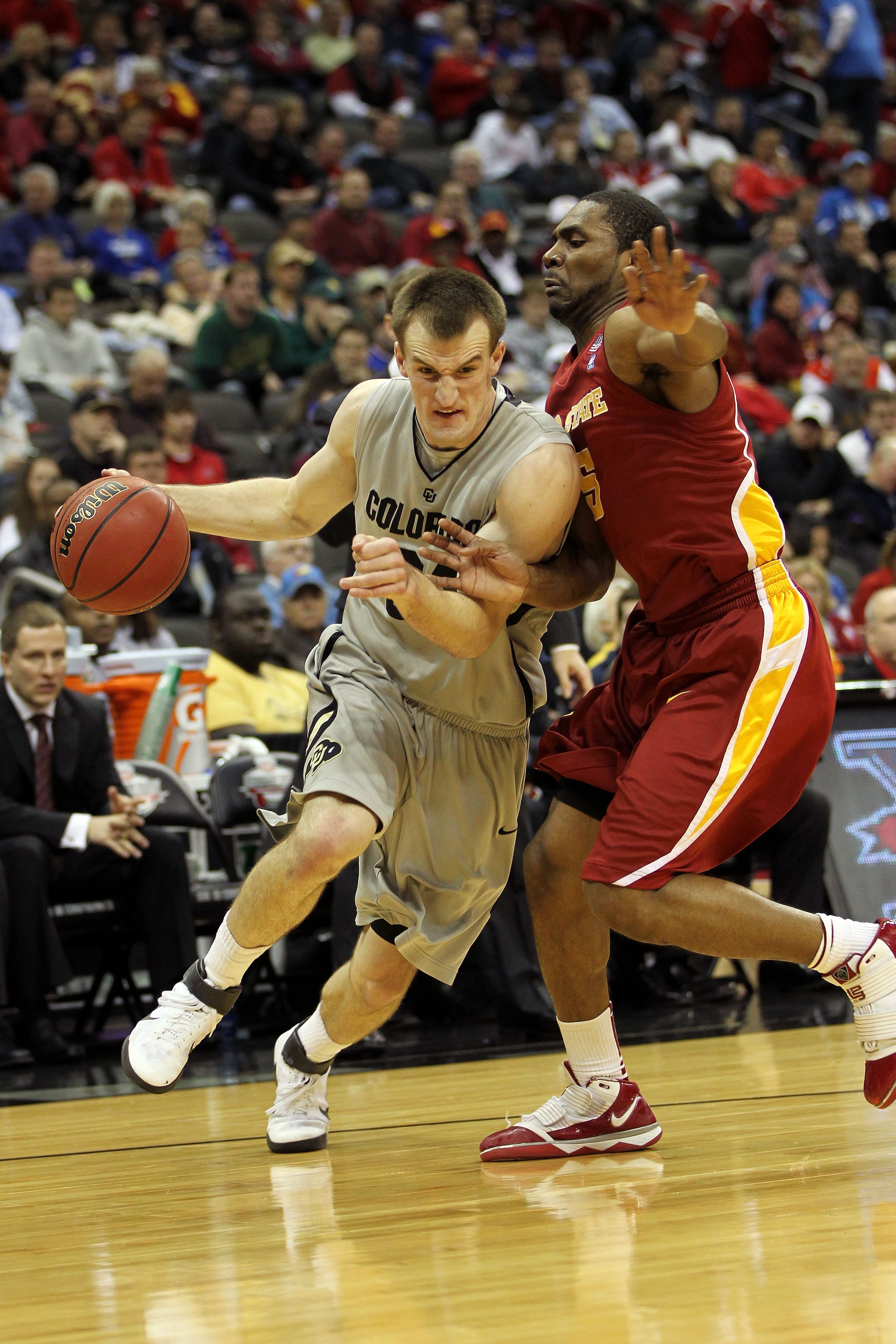 KANSAS CITY, MO - MARCH 09:  Levi Knutson #24 of the Colorado Buffaloes drives with the ball against Darion Anderson #5 of the Iowa State Cyclones during their first round game in the 2011 Phillips 66 Big 12 Men's Basketball Tournament at Sprint Center on