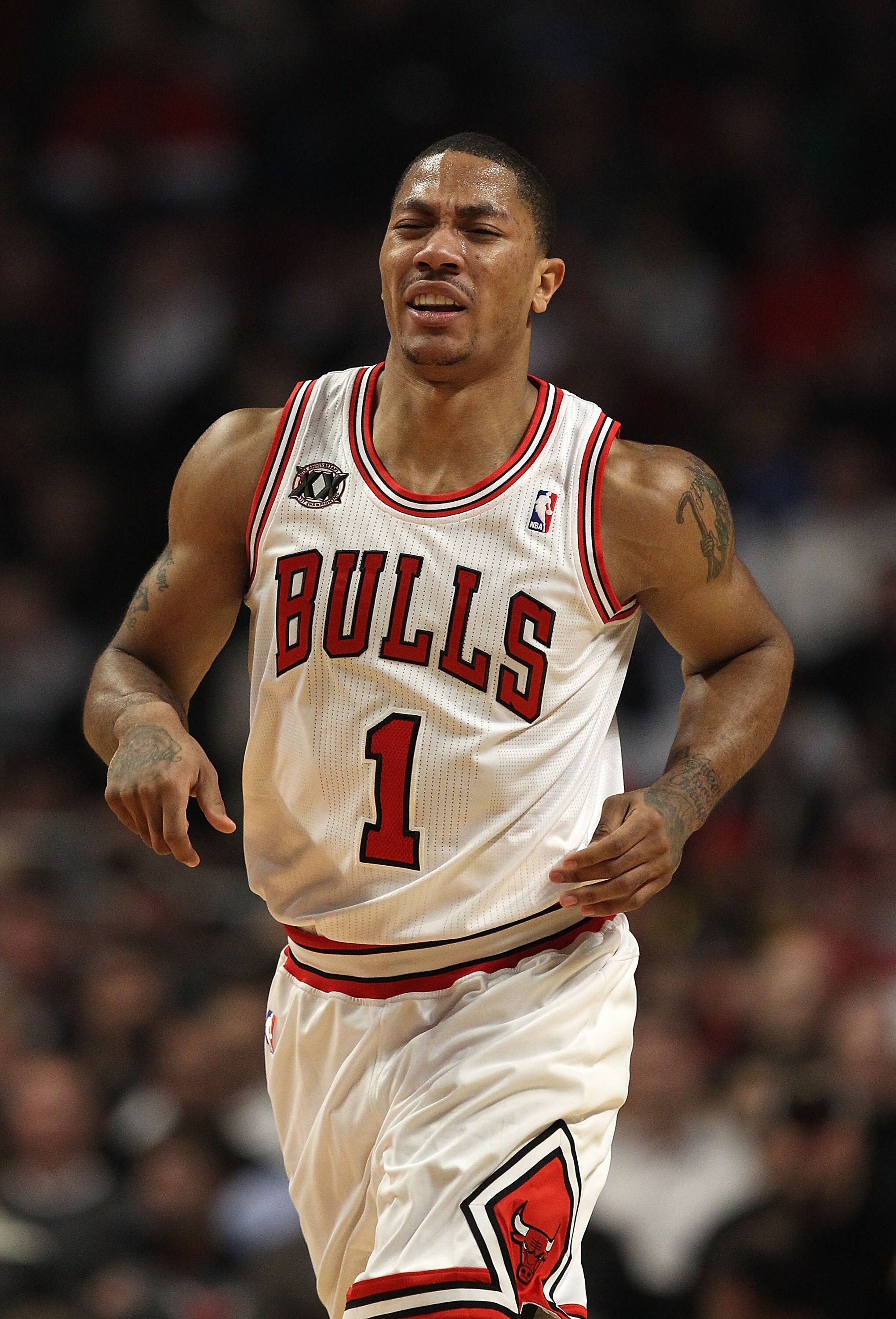 CHICAGO, IL - MARCH 07: Derrick Rose #1 of the Chicago Bulls grimaces as he runs up the court after being poked in the eye on a blocked shot by Emeka Okafor of the New Orleans Hornets at the United Center on March 7, 2011 in Chicago, Illinois. NOTE TO USE
