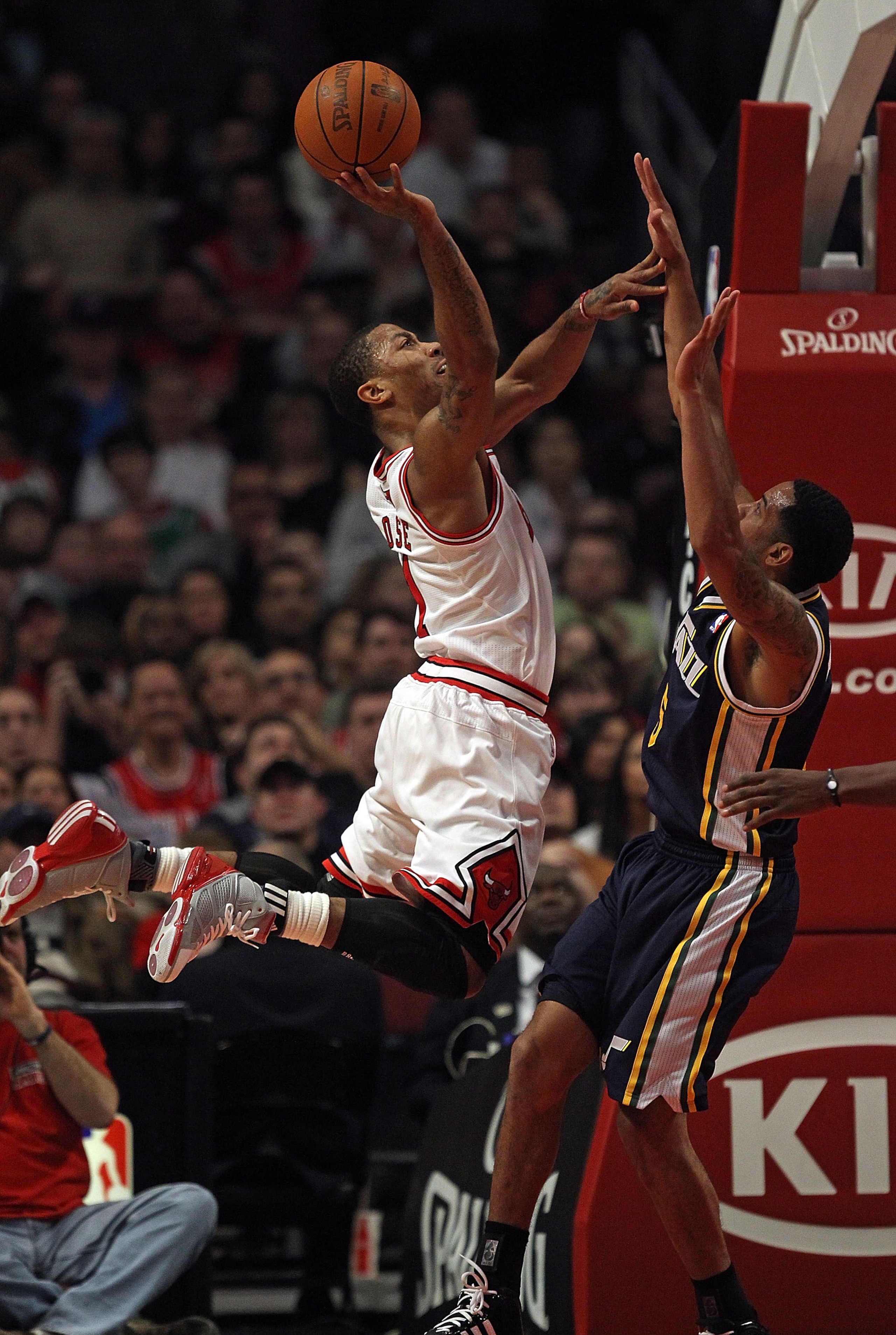 CHICAGO, IL - MARCH 12: Derrick Rose #1 of the Chicago Bulls puts up a shot over Devin Harris #5 of the Utah Jazz at the United Center on March 12, 2011 in Chicago, Illinois. The Bulls defeated the Jazz 118-100. NOTE TO USER: User expressly acknowledges a