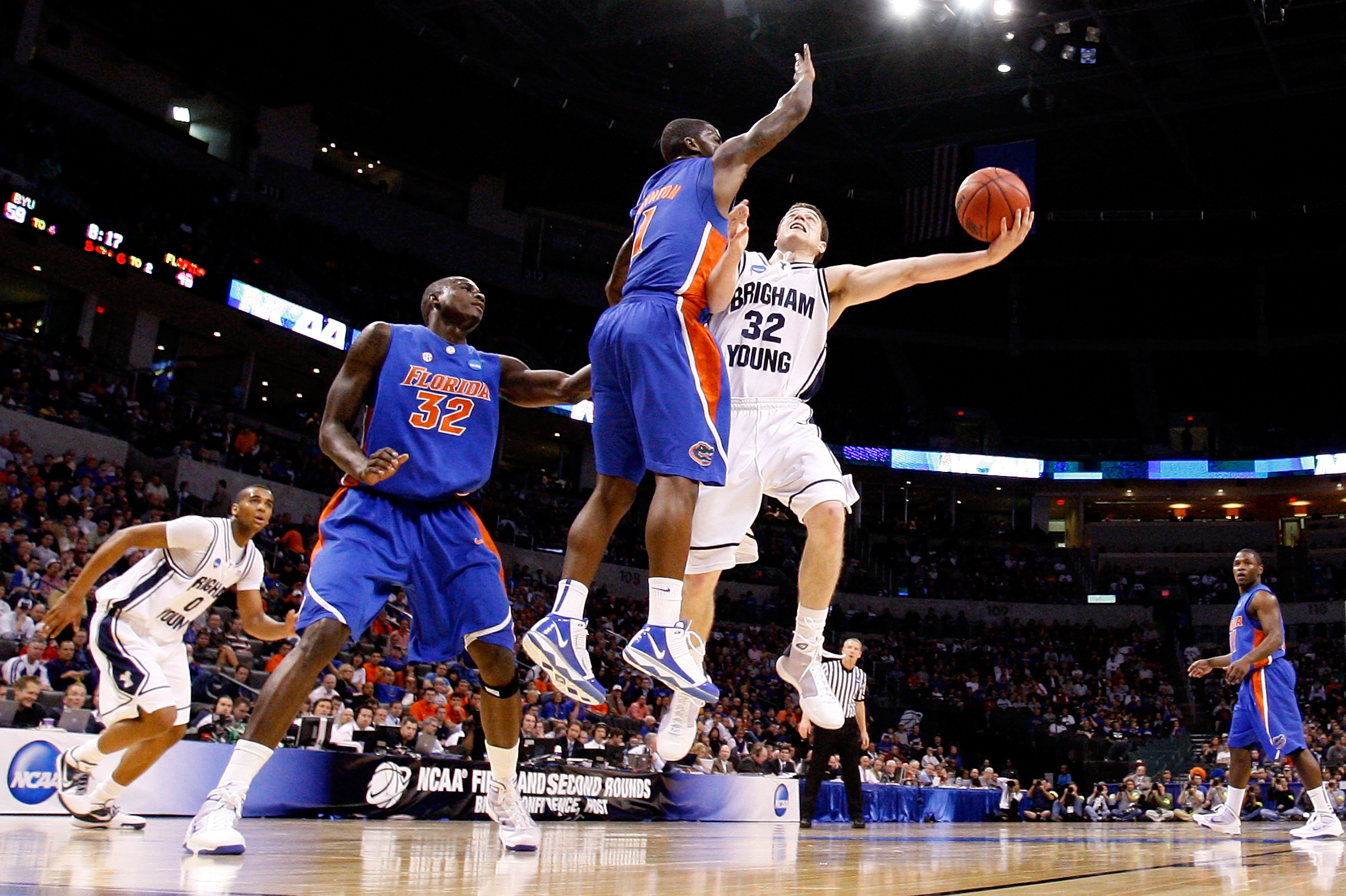 OKLAHOMA CITY - MARCH 18:  Jimmer Fredette #32 of the BYU Cougars drives for a shot attempt against Kenny Boynton #1 of the Florida Gators during the first round of the 2010 NCAA men�s basketball tournament at Ford Center on March 18, 2010 in Oklahoma Cit