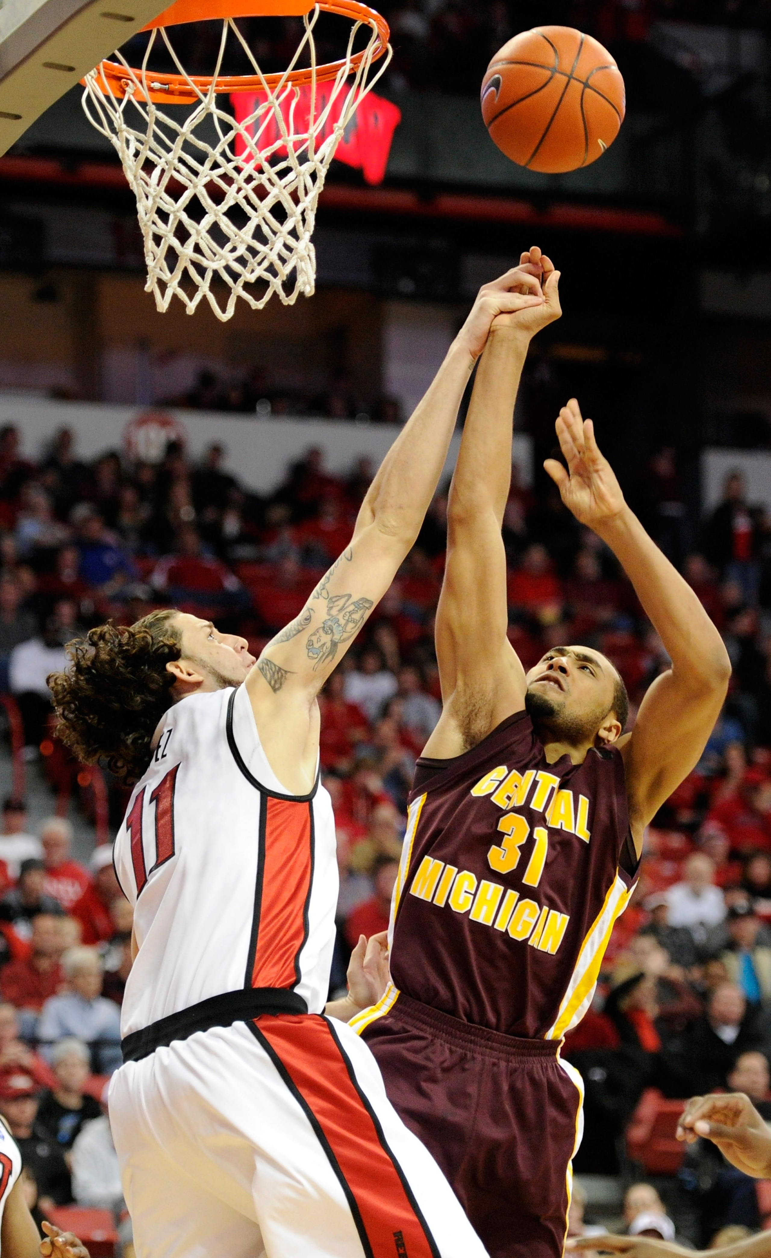 LAS VEGAS, NV - DECEMBER 30:  Jalin Thomas #31 of the Central Michigan Chippewas shoots against Carlos Lopez #11 of the UNLV Rebels during their game at the Thomas & Mack Center December 30, 2010 in Las Vegas, Nevada. UNLV won 73-47.  (Photo by Ethan Mill